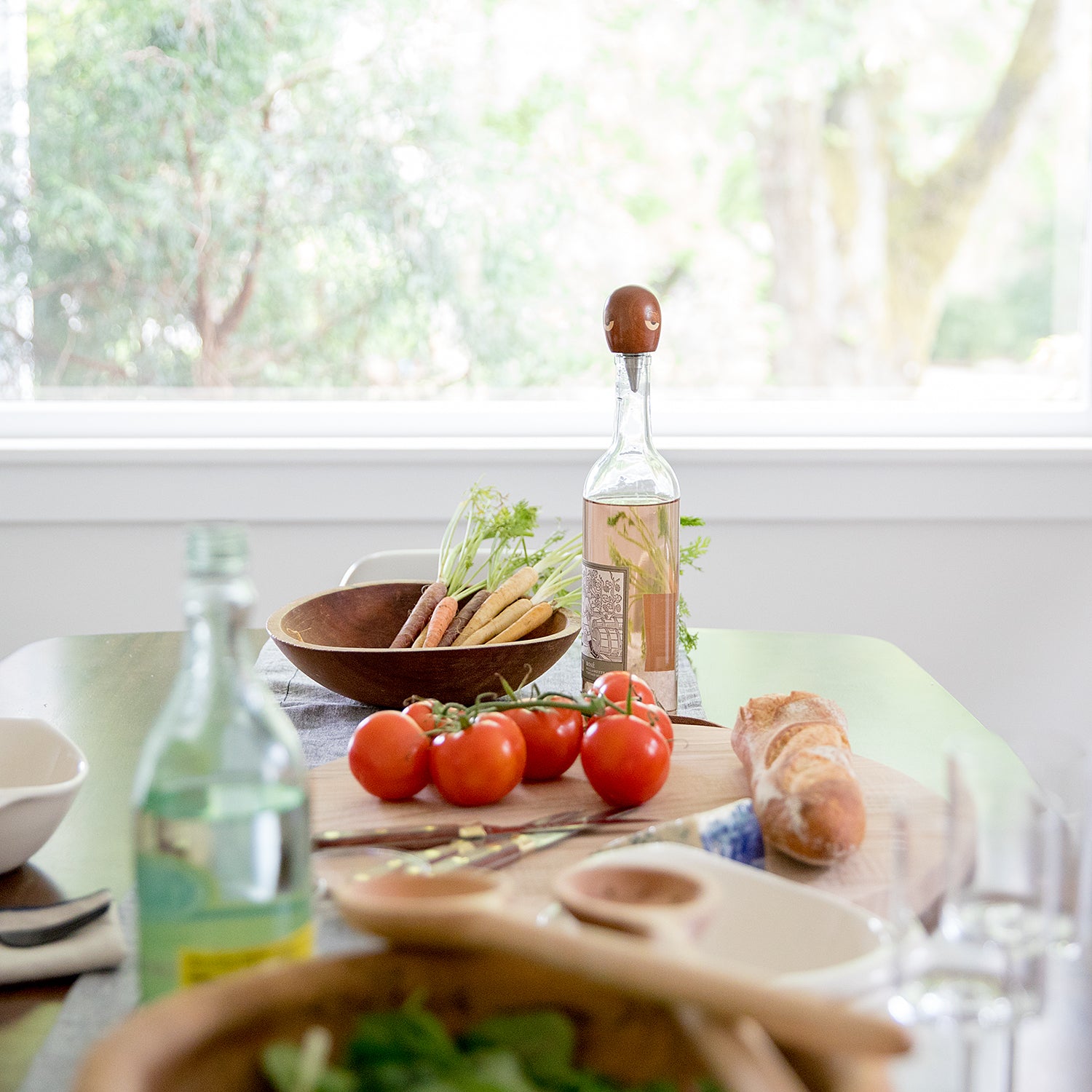 tomatoes and bread on a platter on a table