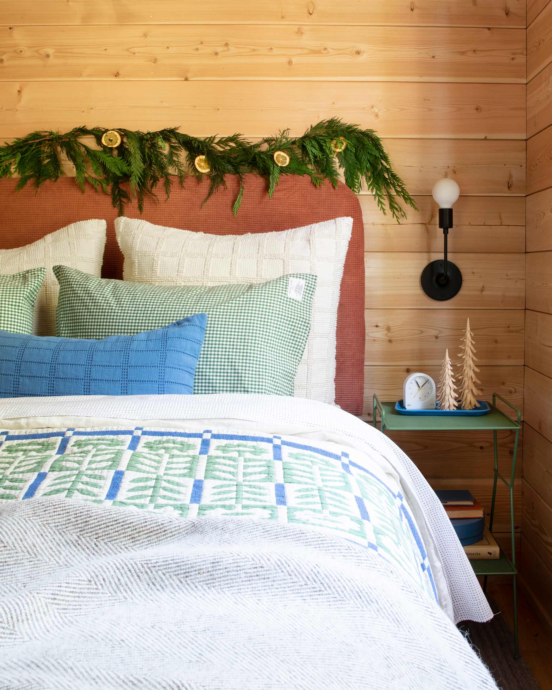 Cozy bed with Juniper green floral Stillwater quilt and other heirloom bedding by Schoolhouse.