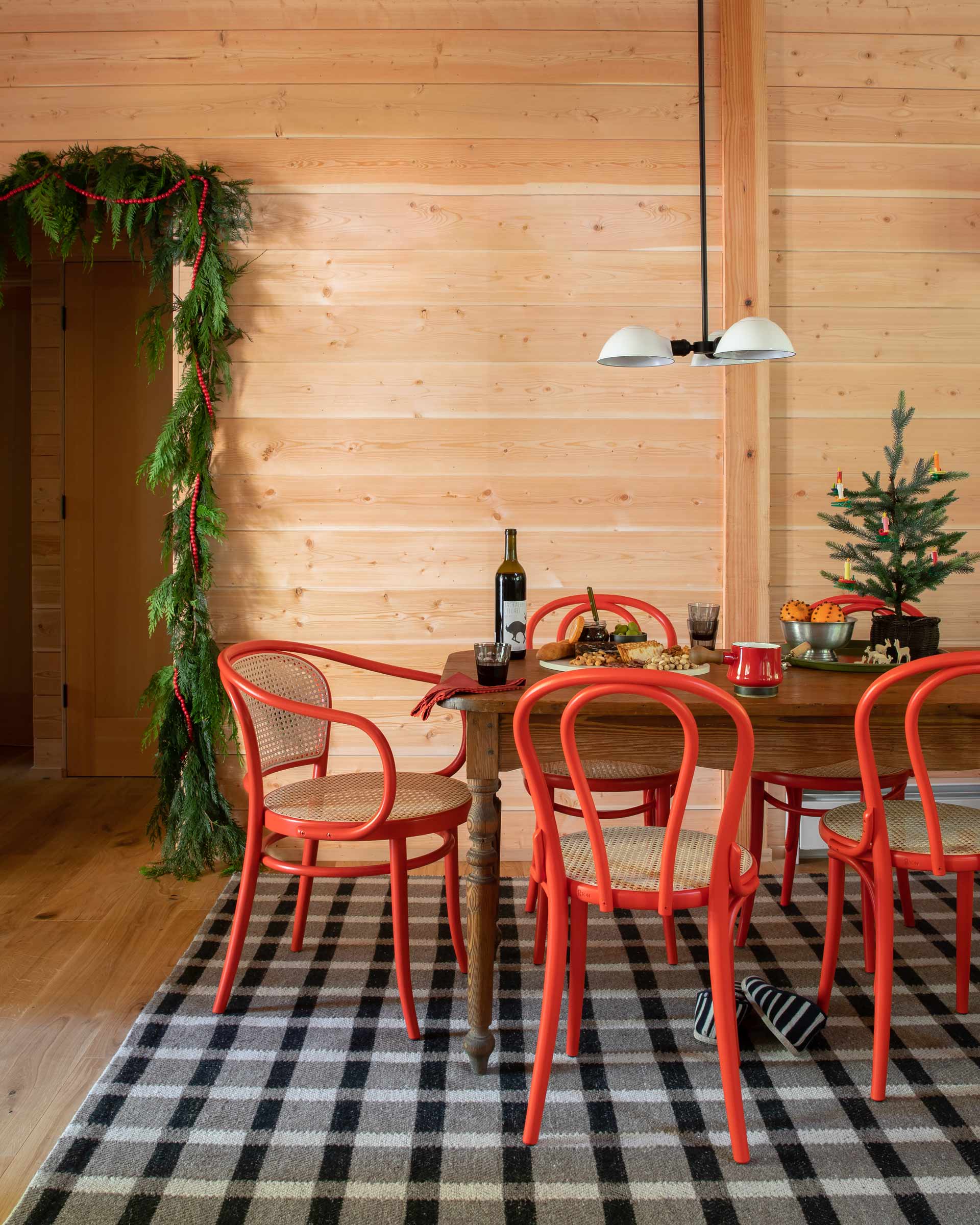 Dining area with red bentwood chairs.