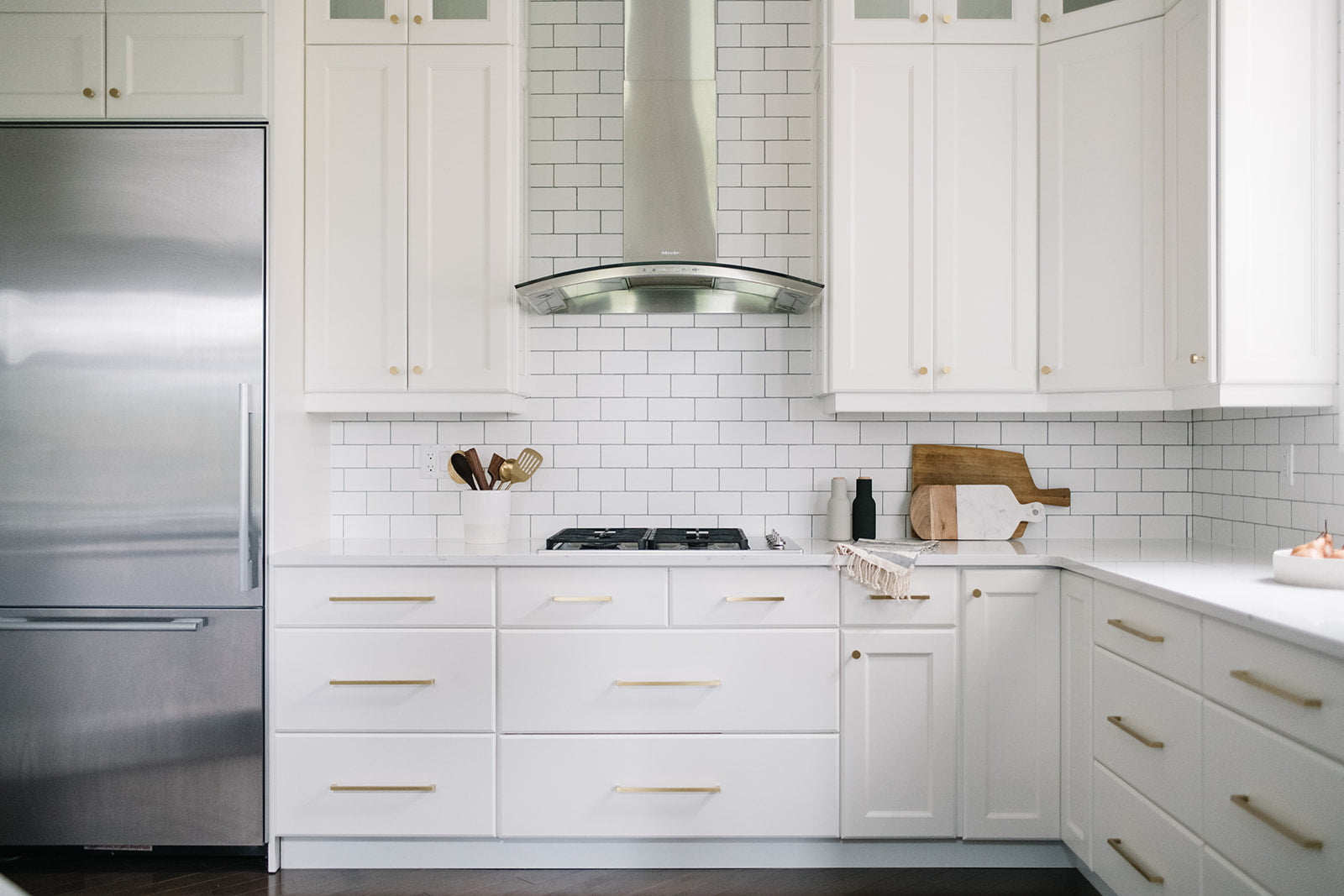 kitchen with white cabinets and a stainless steel refrigerator