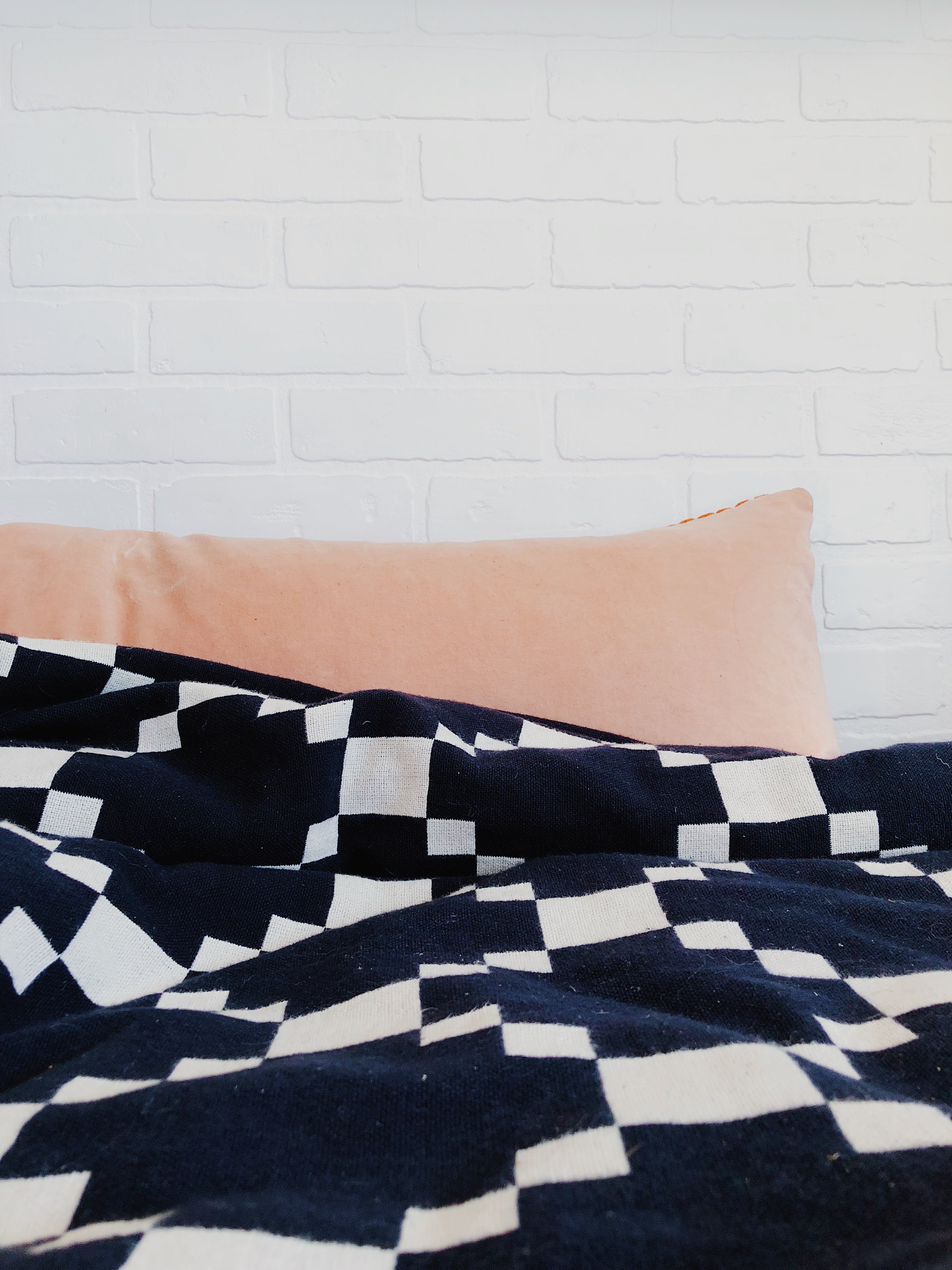 black and white blanket on a bed