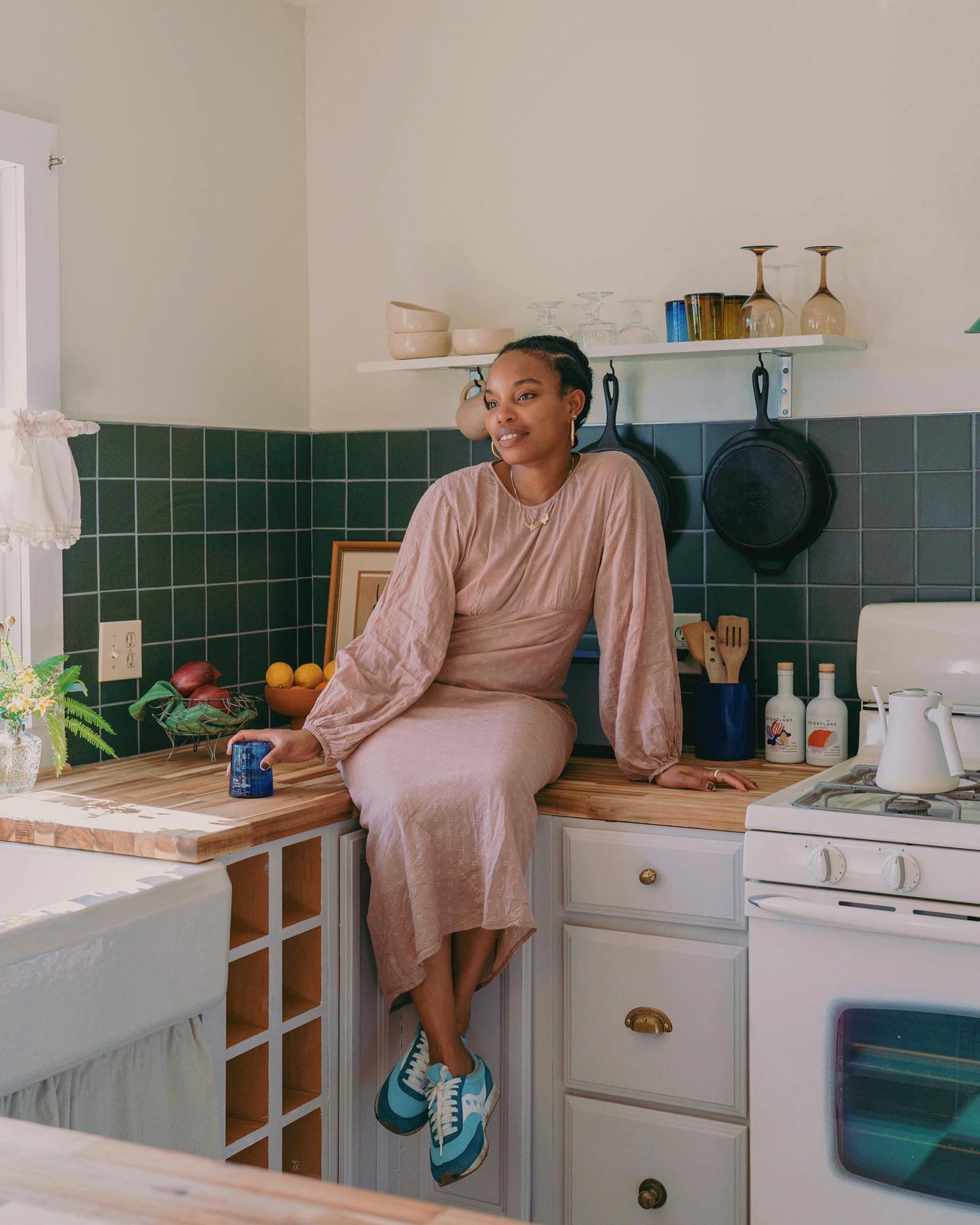 Latonya sitting on the kitchen counter at The Mae House. 