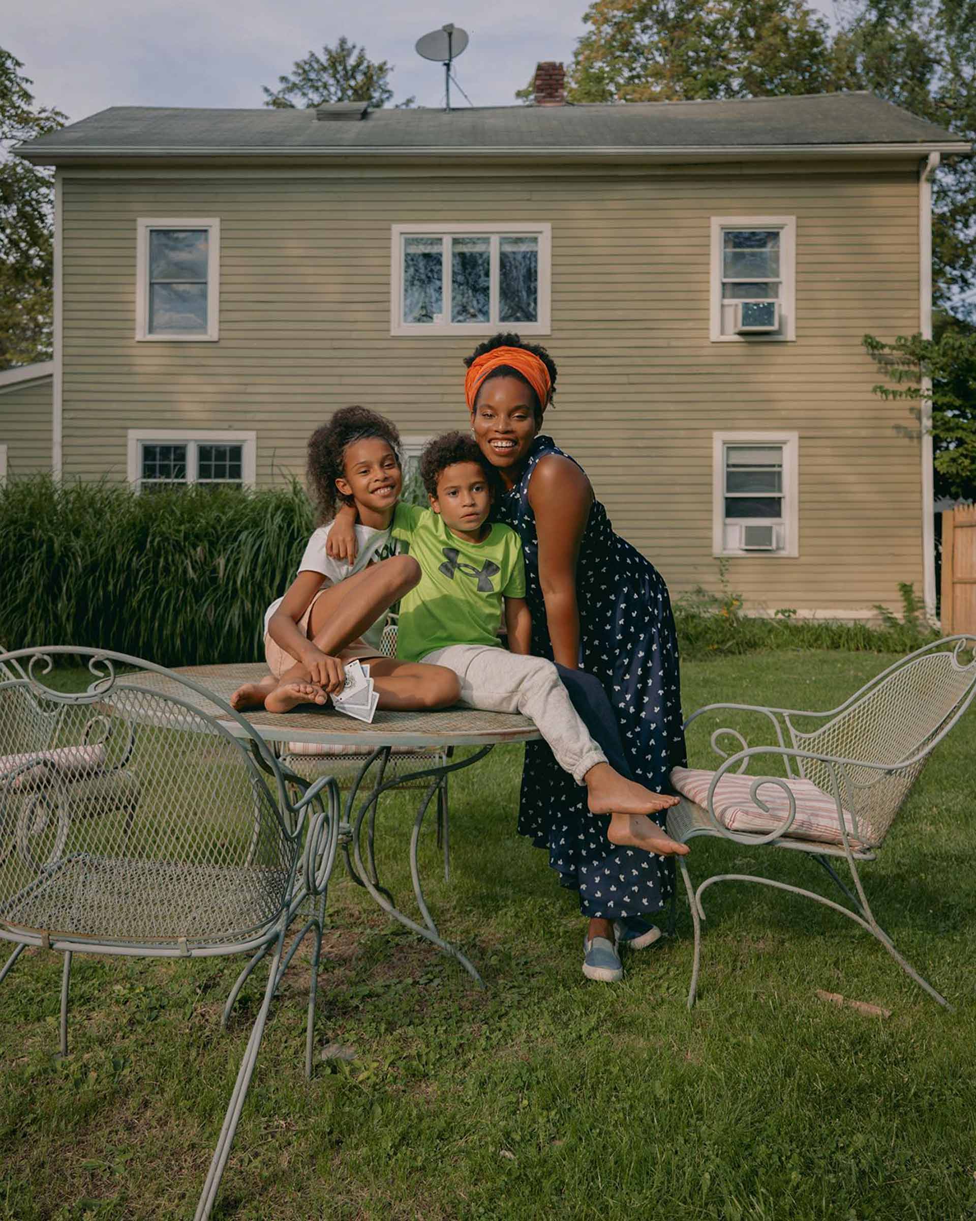 LaTonya with her kids in the backyard of The Mae House. 