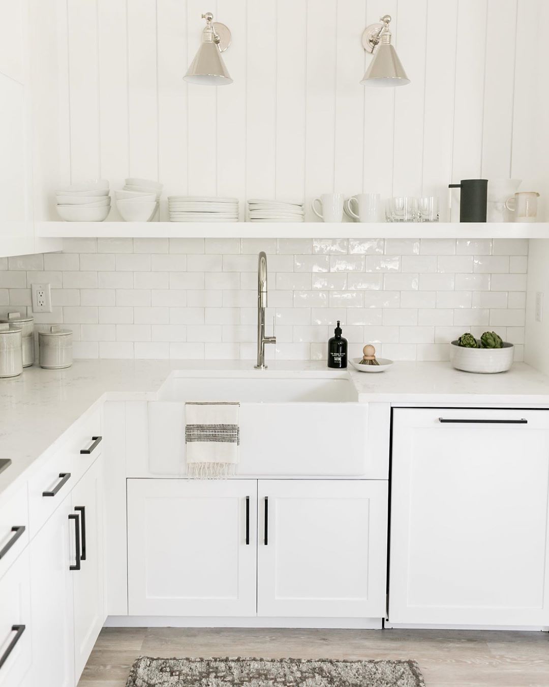 kitchen with white cabinets and white dishware on shelves