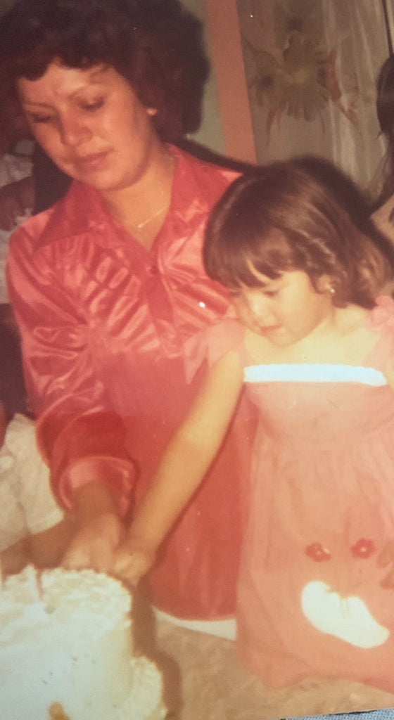 person and a child looking at a cake