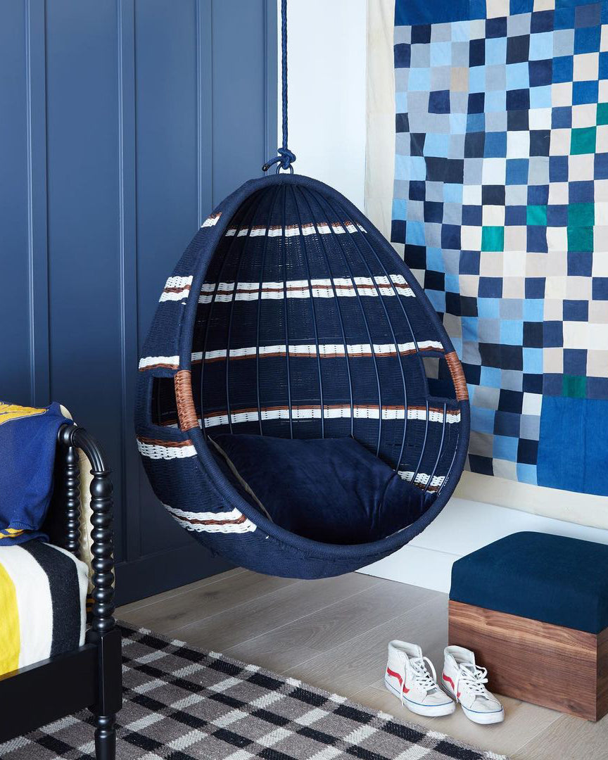 navy blue and white hanging chair in the corner of a room
