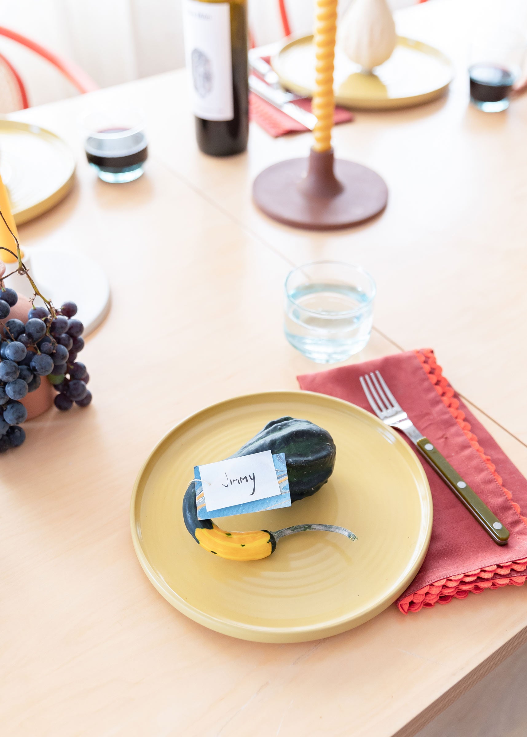 Mini gourd name cards on playful table setting.