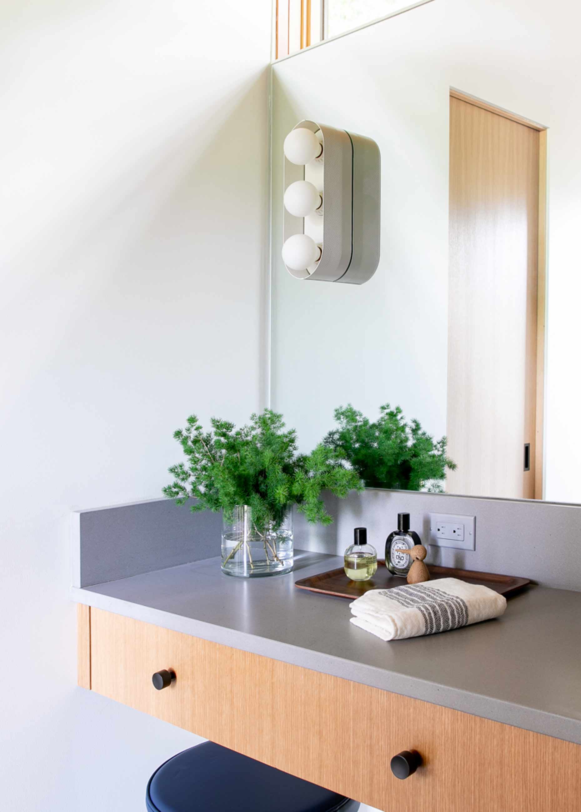 Sleek and modern bathroom with floating vanity and large mirror.