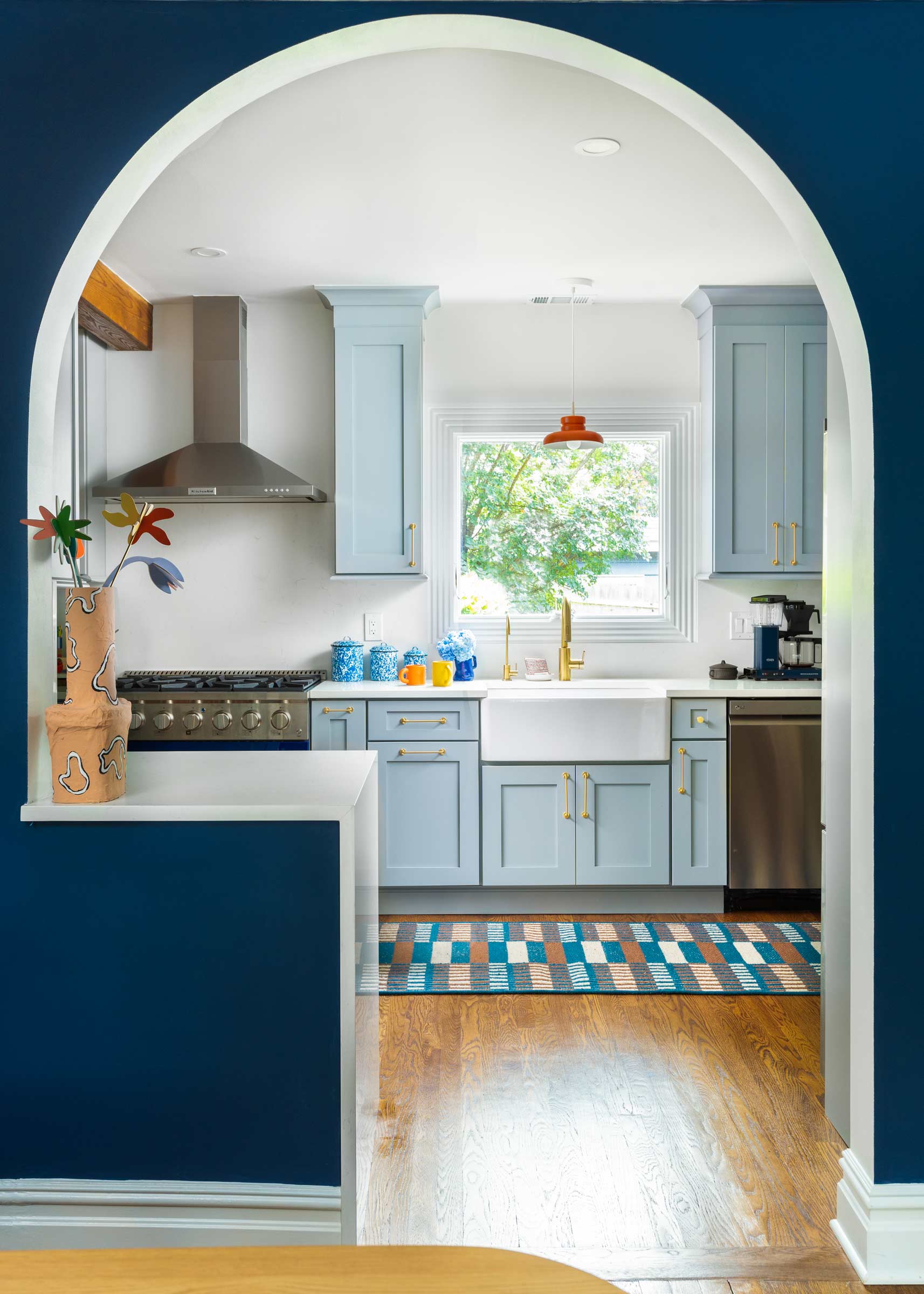 Modern kitchen with red pendant light over sink.