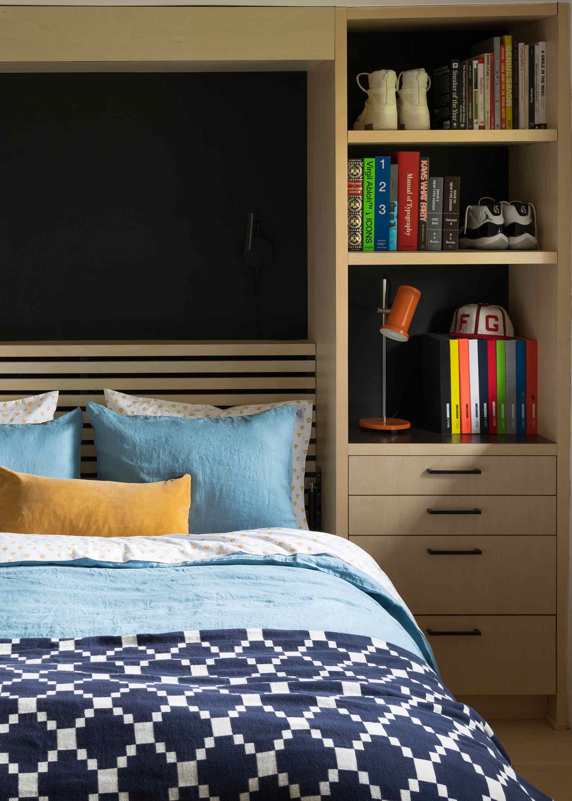 Murphy bed with blue bedding.