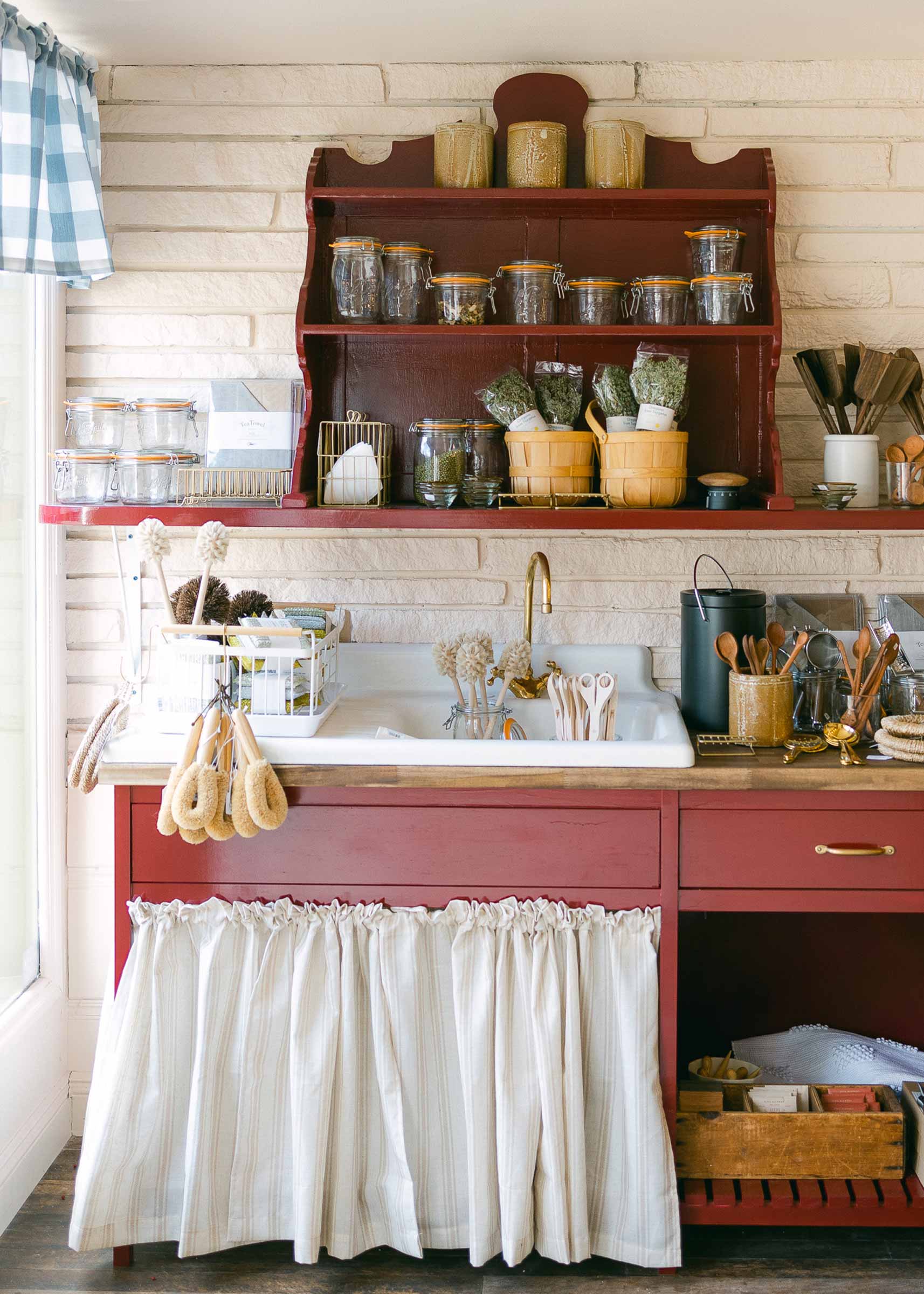 Red shelf and counter in shop full of unique treasures. 