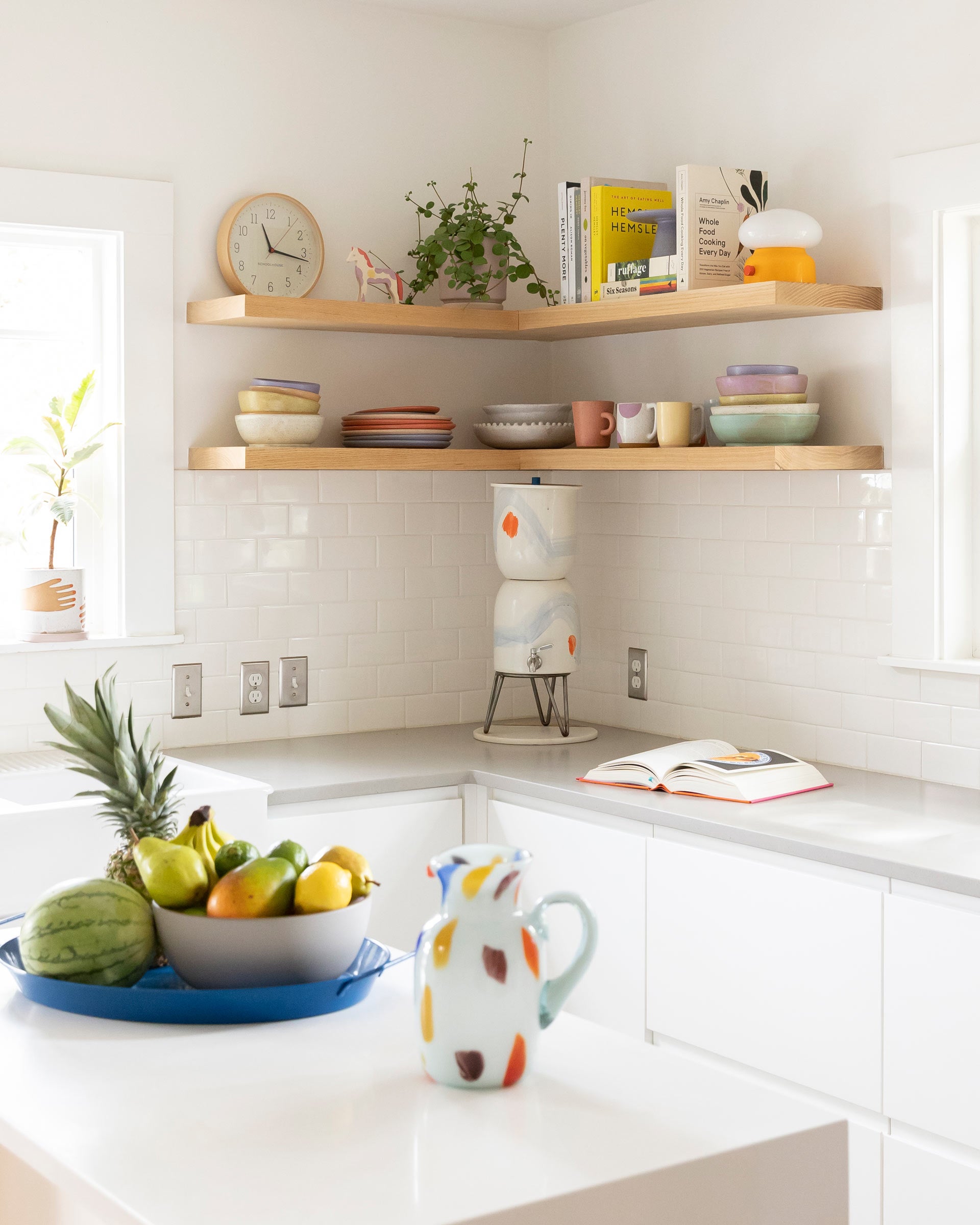 Open shelving in a kitchen with a yellow mushroom shaped table lamp.