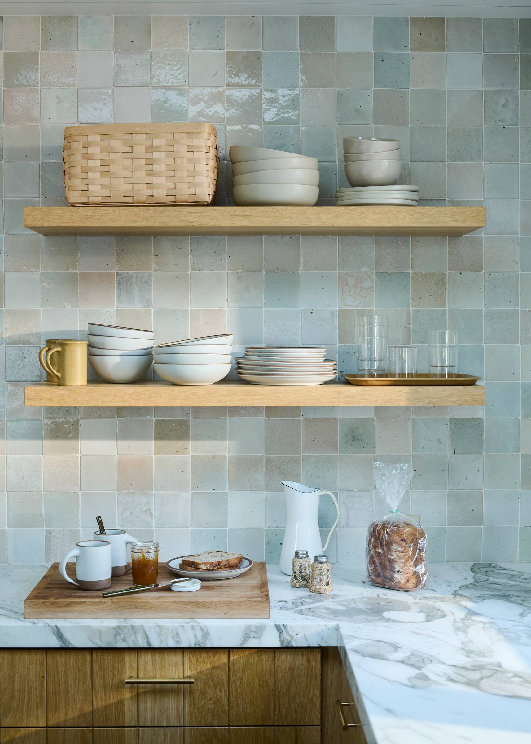 Open kitchen shelving with ceramic bowls.