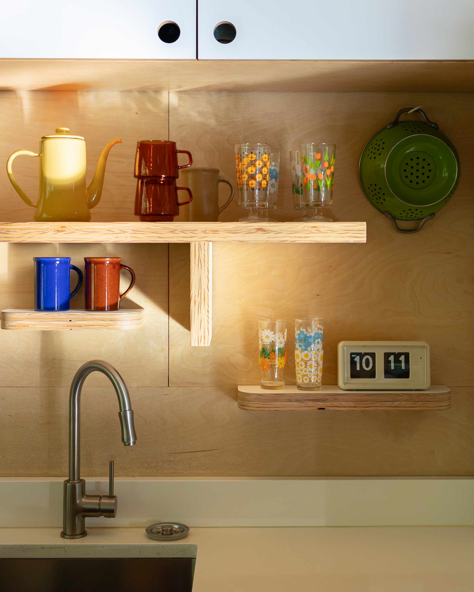 Organized open kitchen shelves.