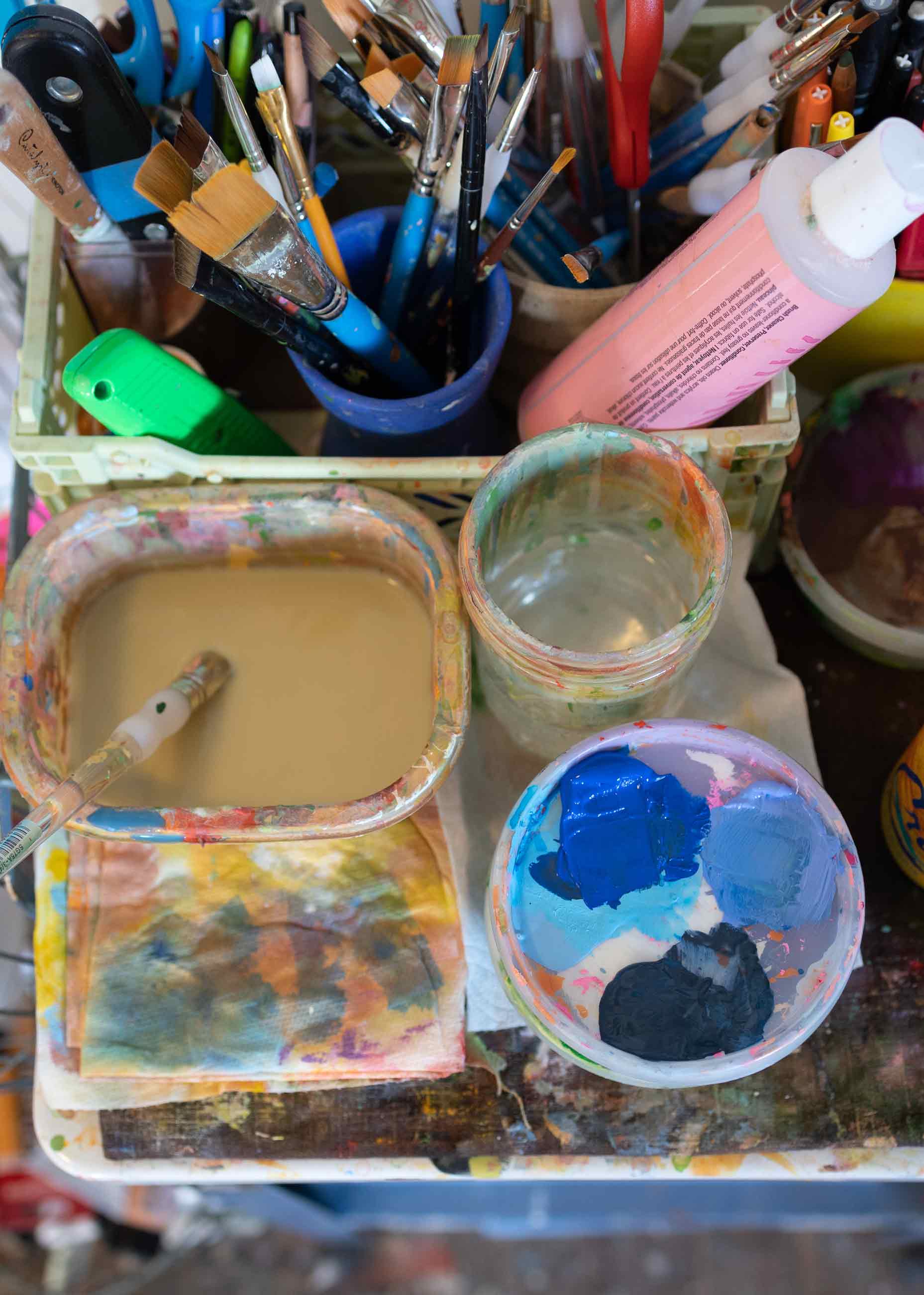 Up close image of paint and brushes. 