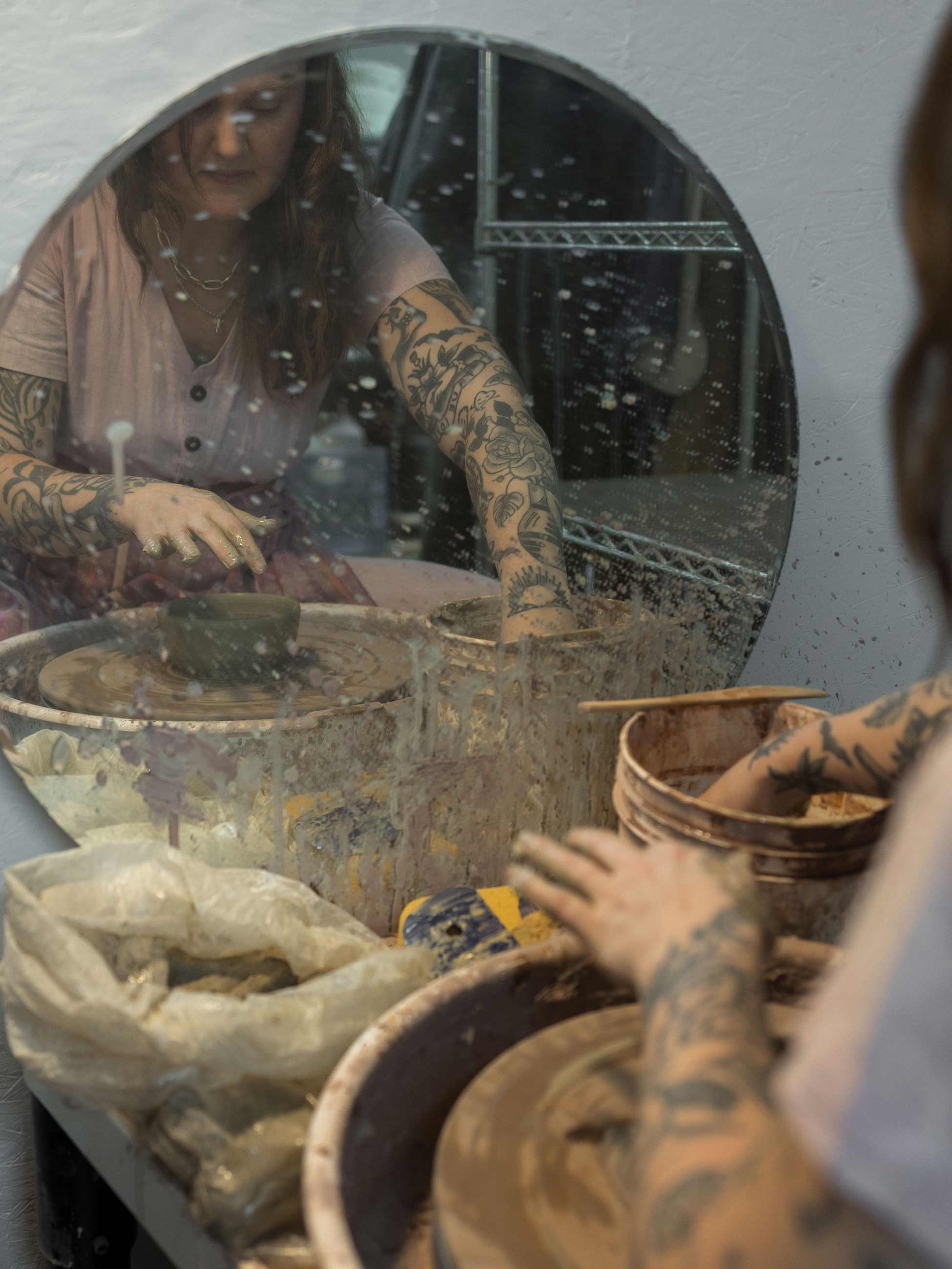 Person throwing ceramics on wheel.