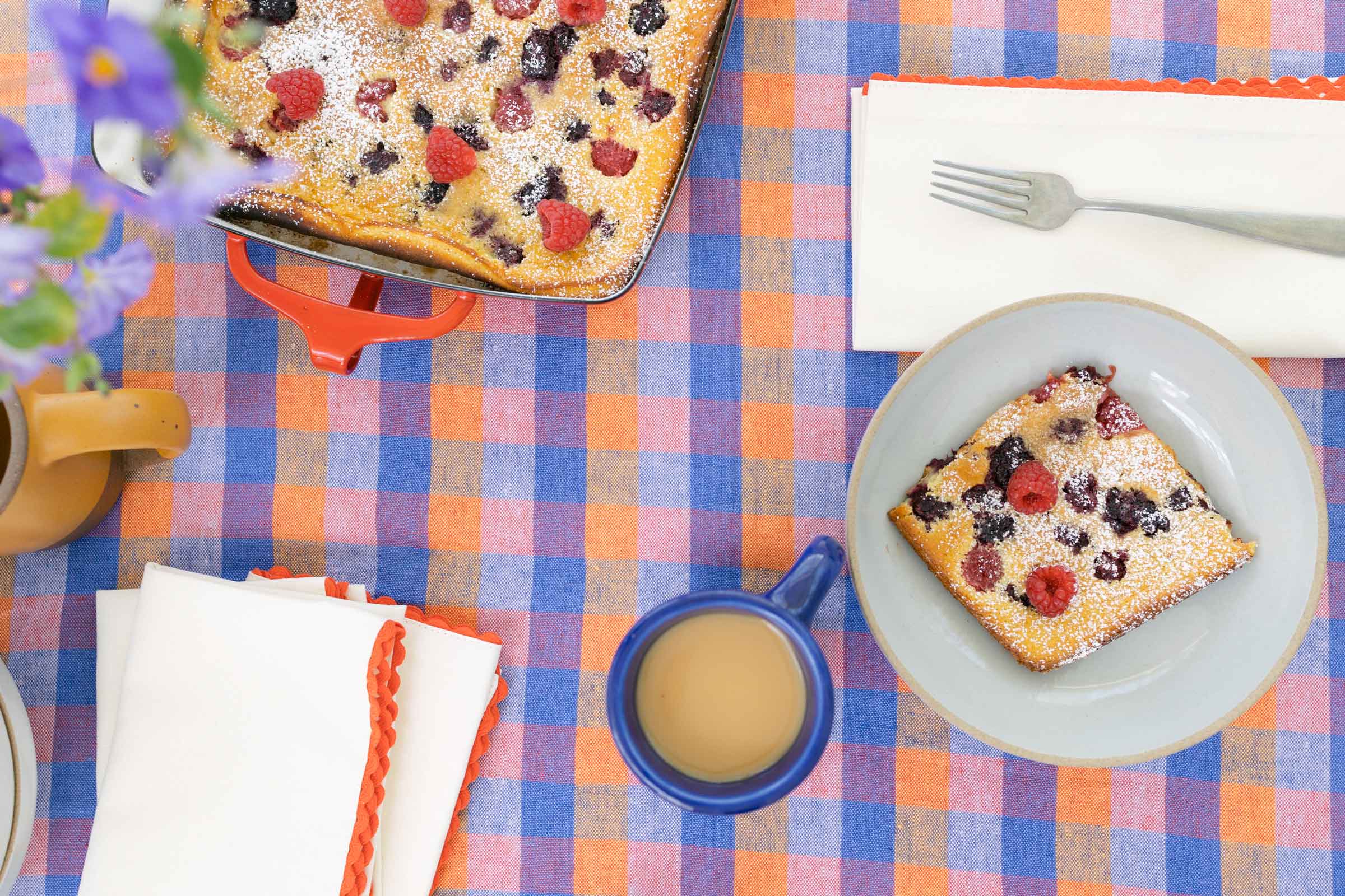 A plaid tablecloth on a summery table. 