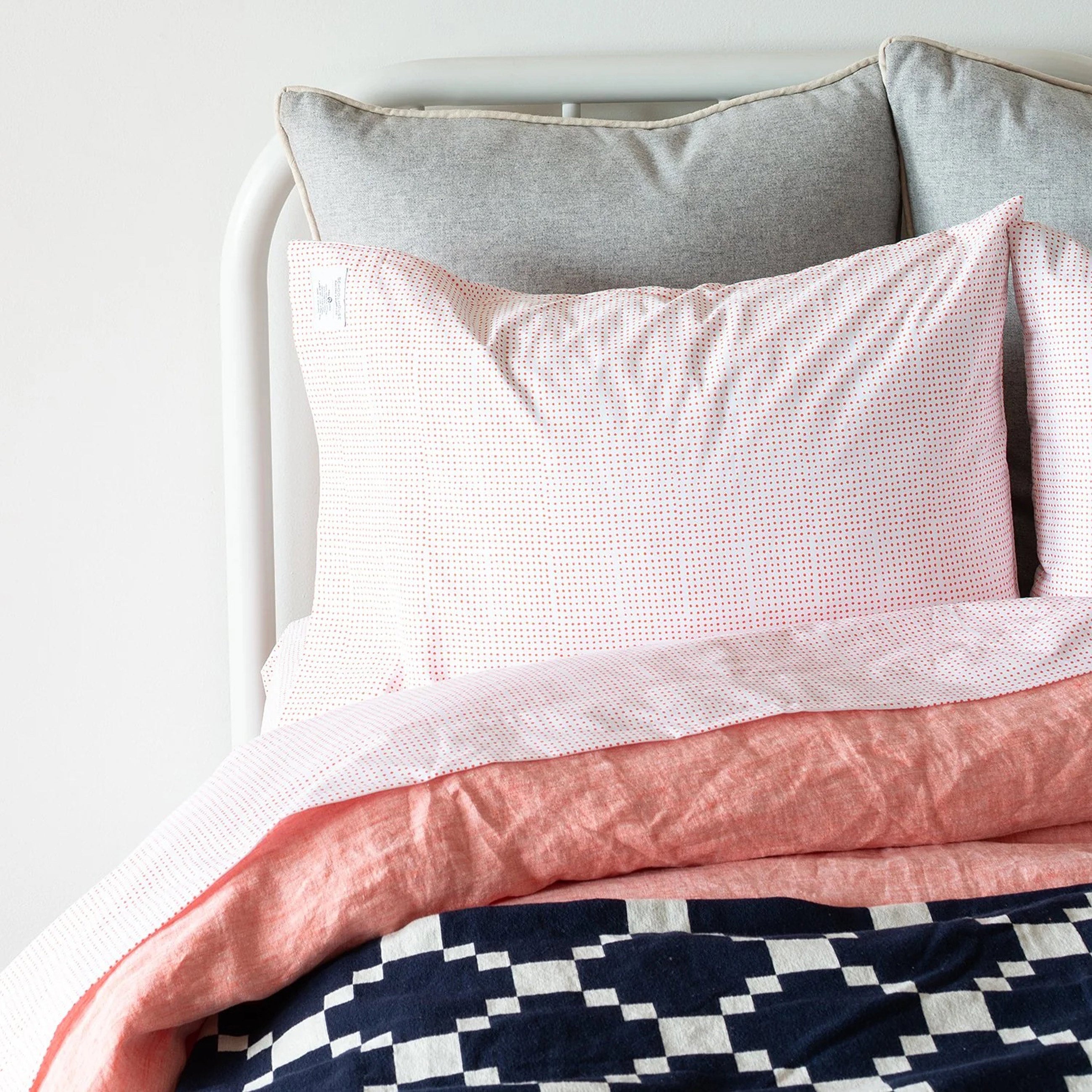 Poppy dot sheet set on white frame bed.