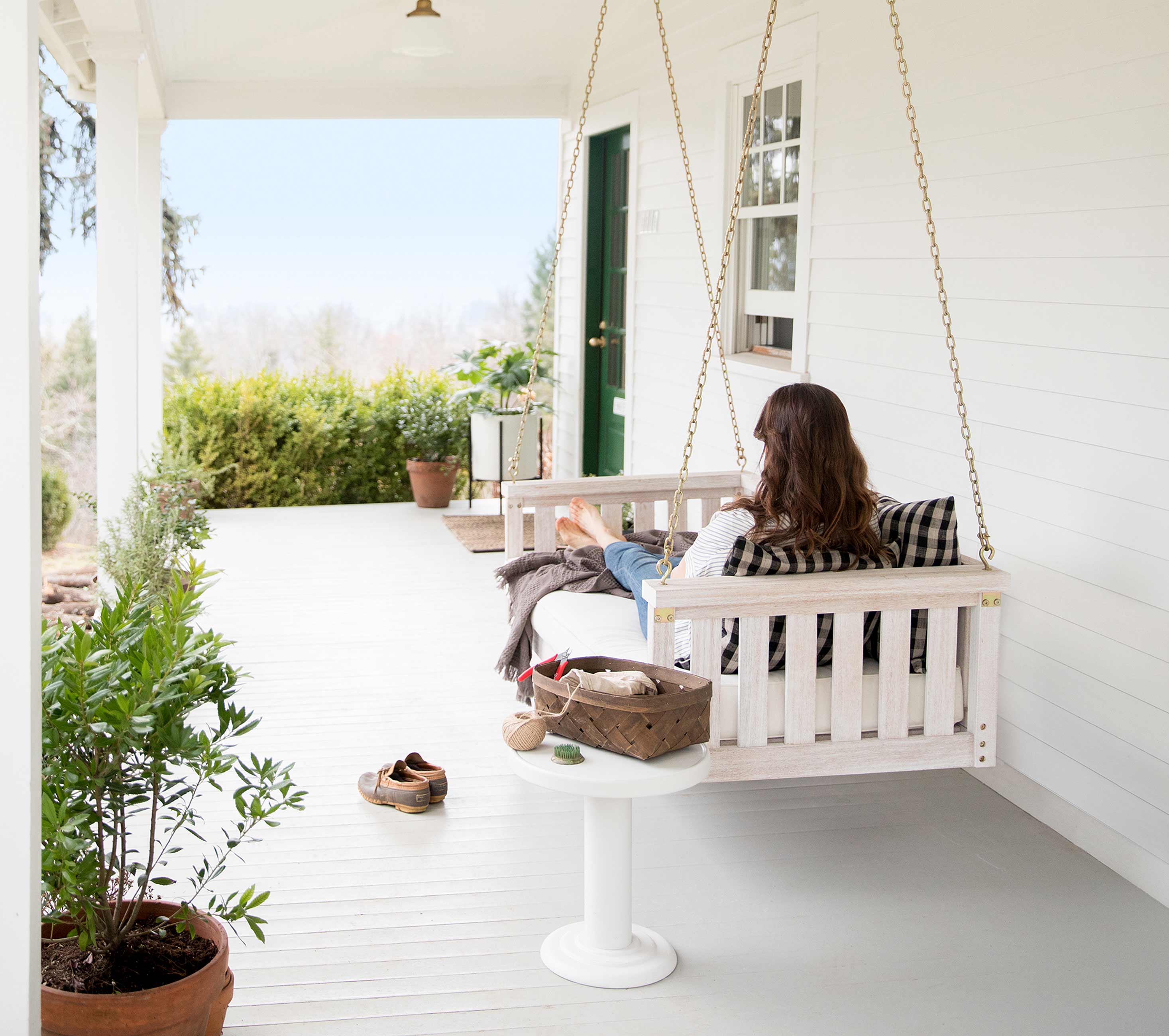 Person sitting on porch swing.