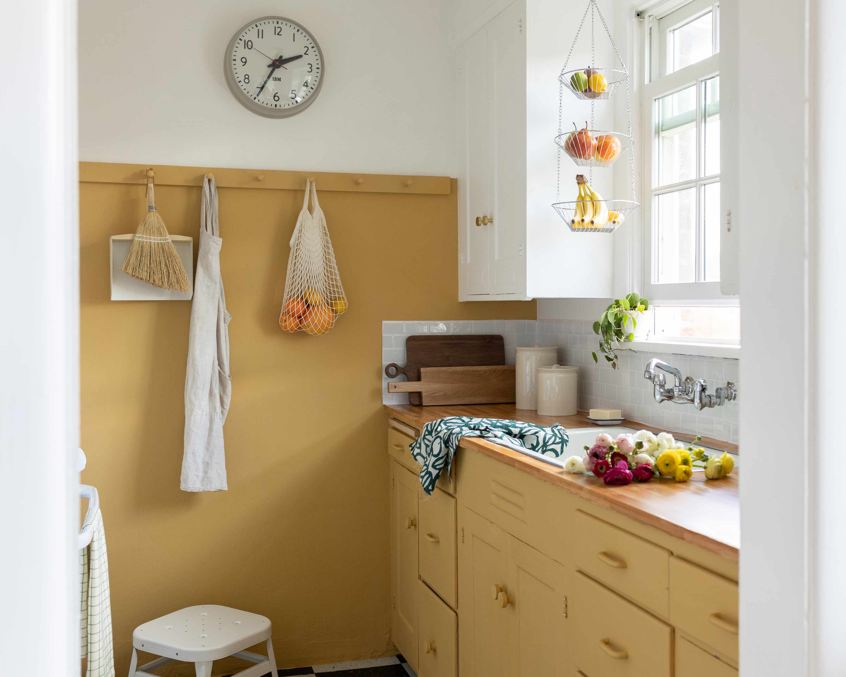 Sunny kitchen with yellow cabinets. 