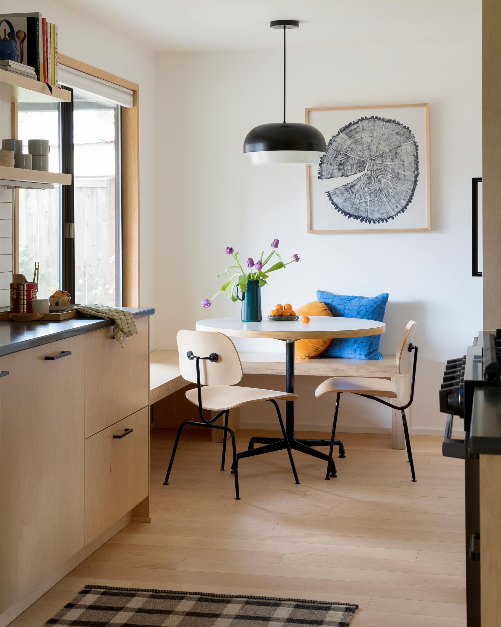 Ray pendant in a kitchen nook over a round table.