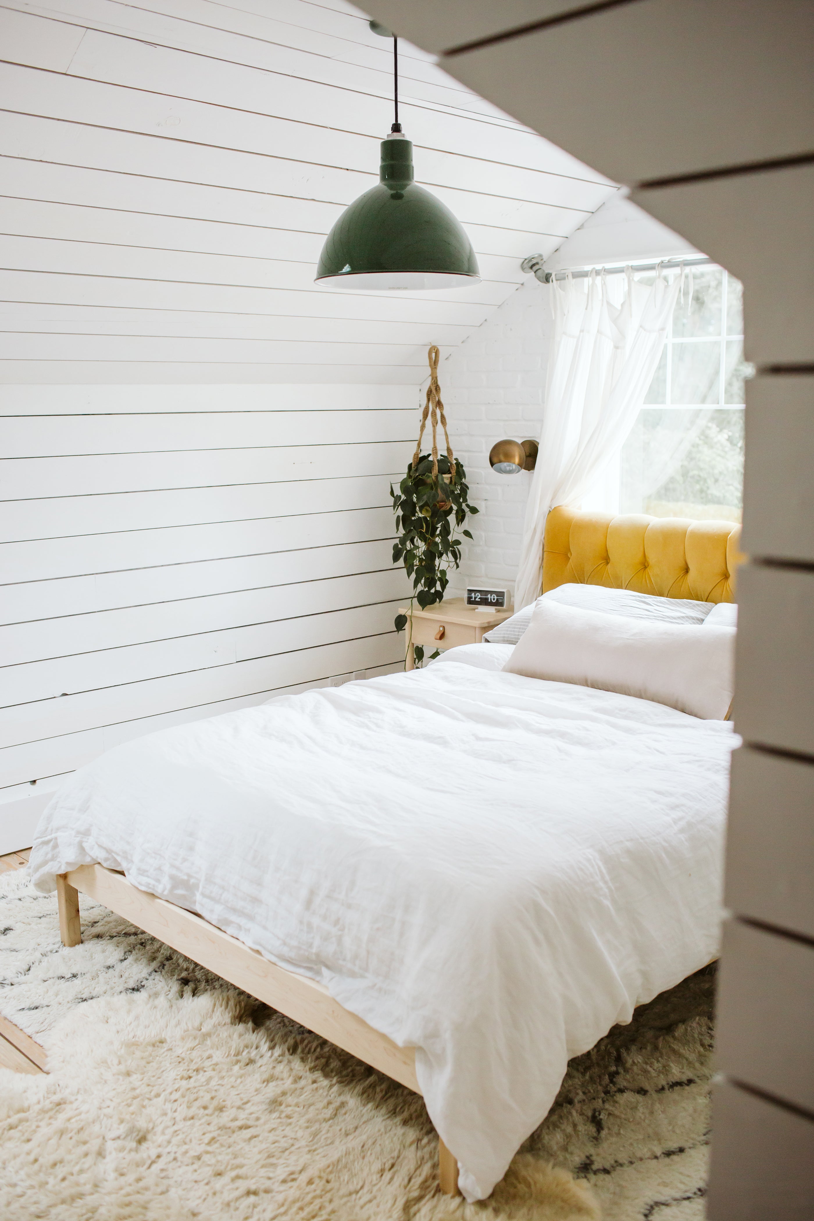 bedroom with a white bed and a yellow headboard