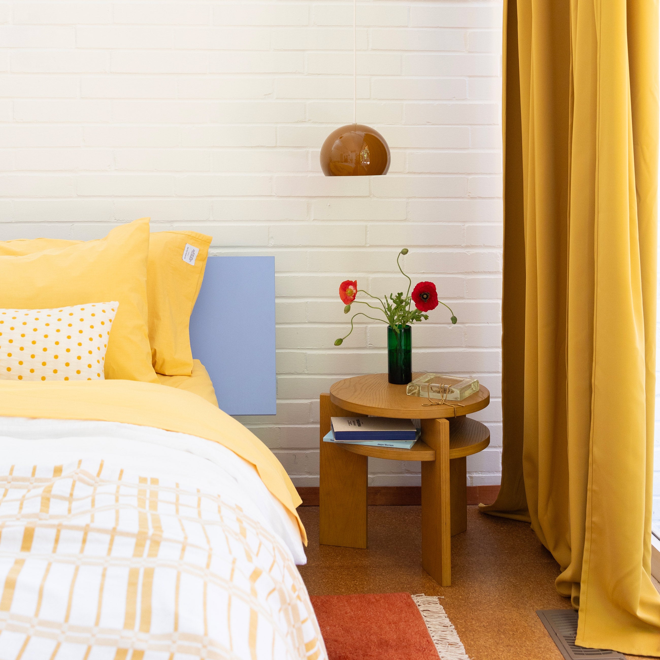 Cozy quilt on bed in bright, colorful bedroom. 