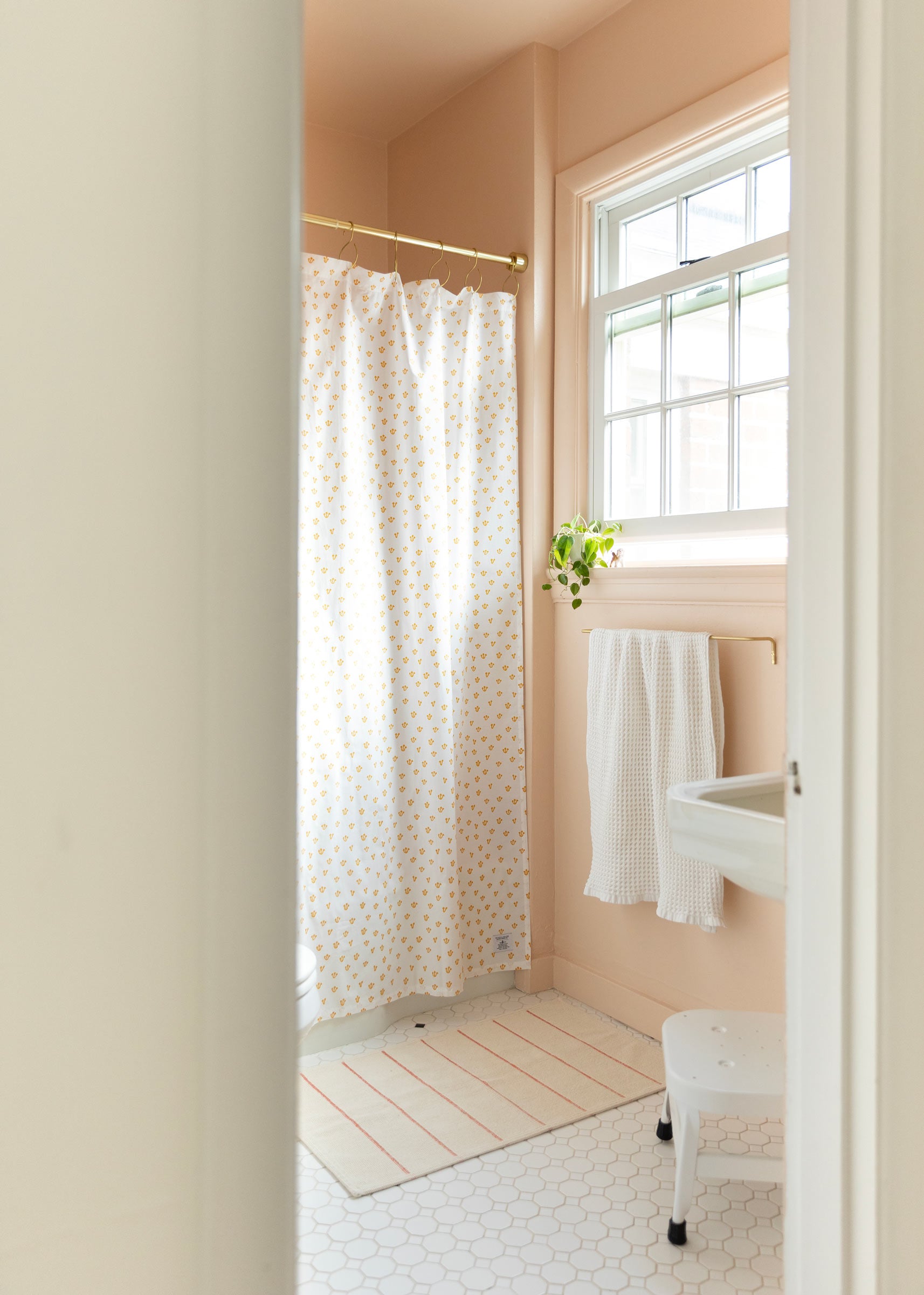 Patterned shower curtain in a small bathroom.