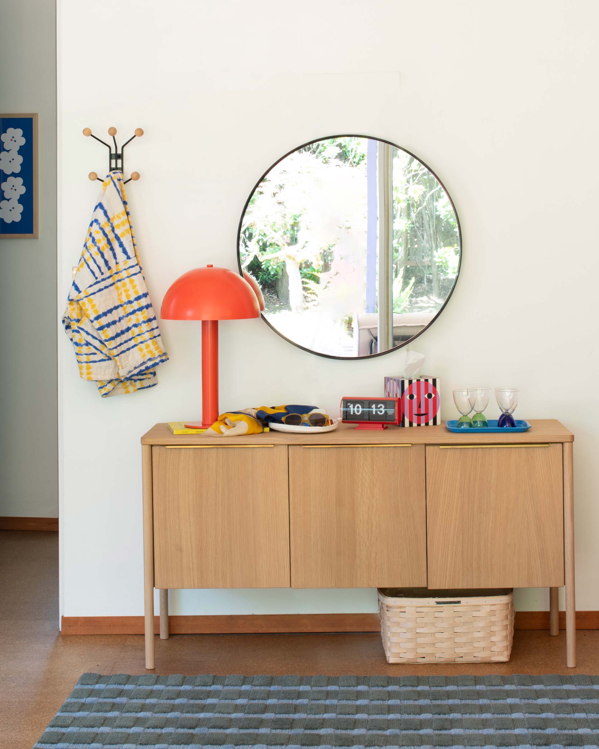 The Sidnie Lamp in persimmon on a sideboard.