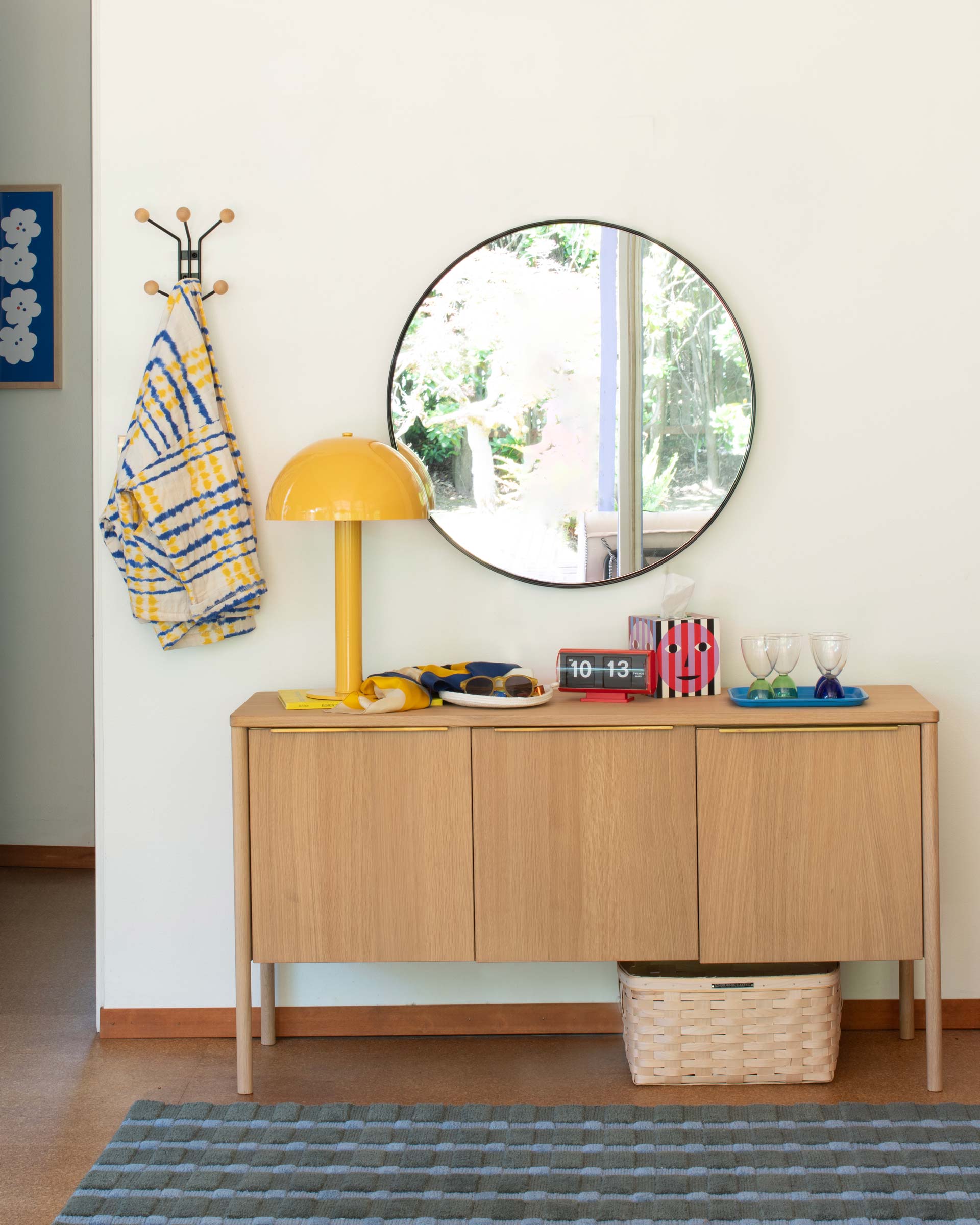 The Sidnie Lamp in Chamomile Gloss on a sideboard.