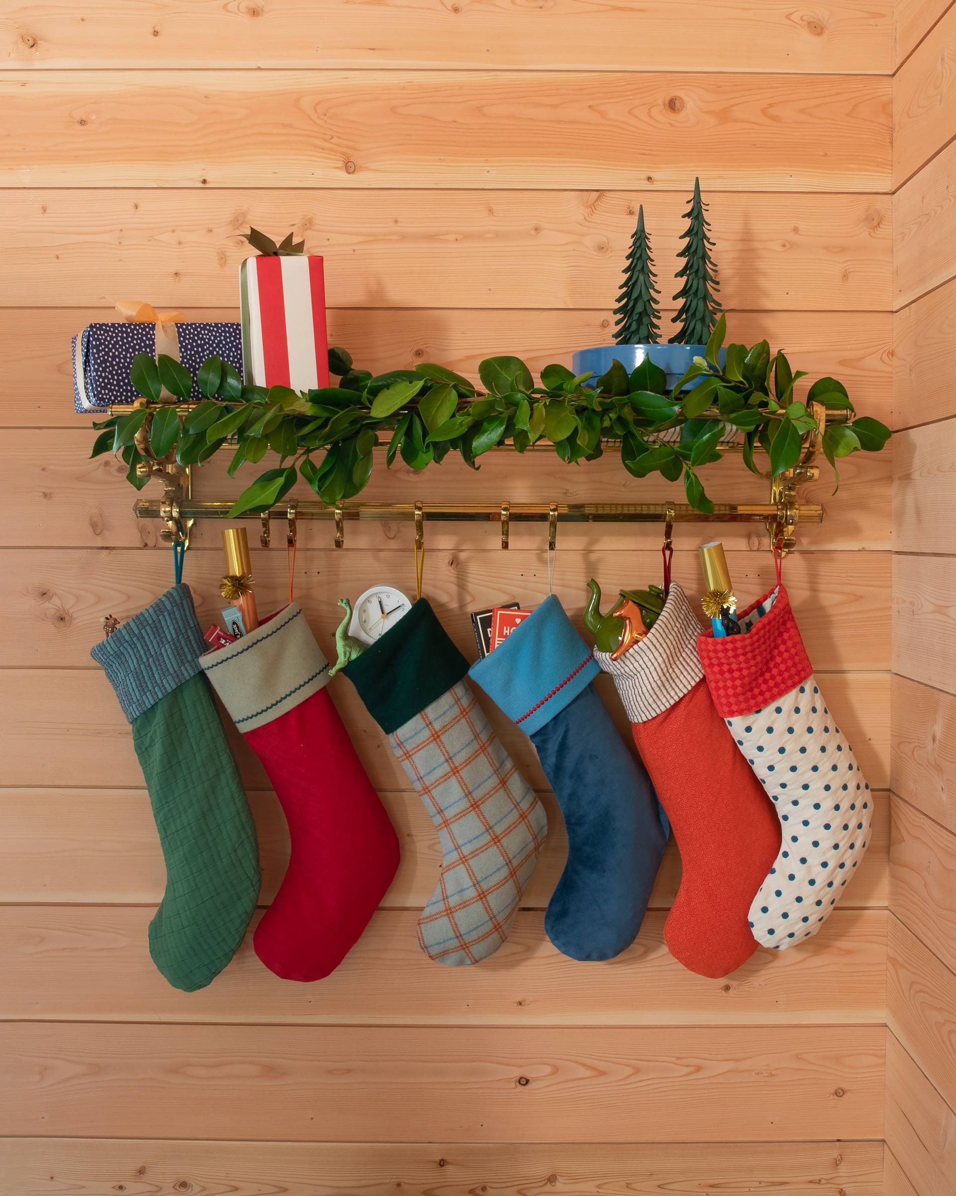 Stockings hanging on an entryway wall-mounted coat rack.