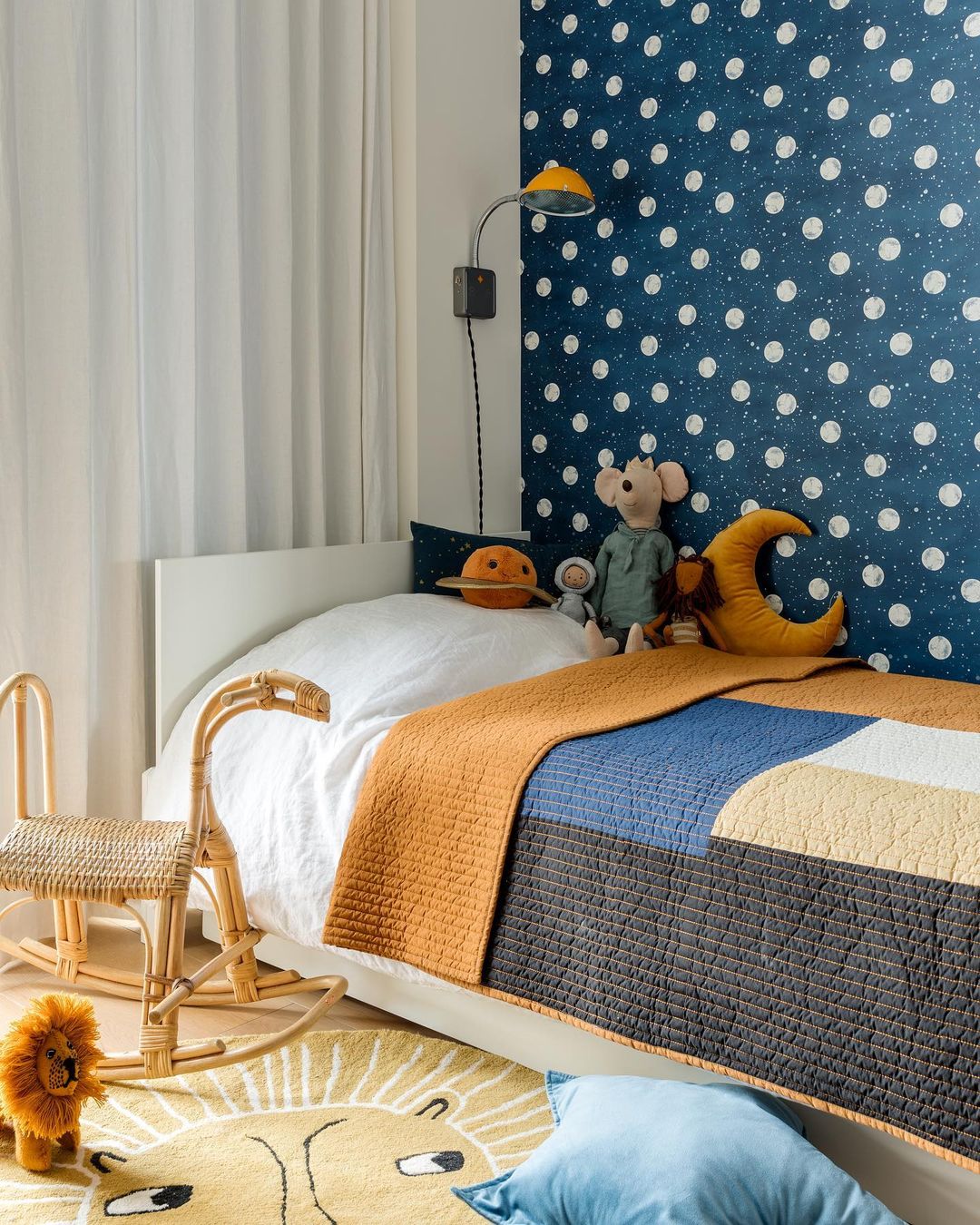 bed with stuffed animals on the side and yellow bedspread
