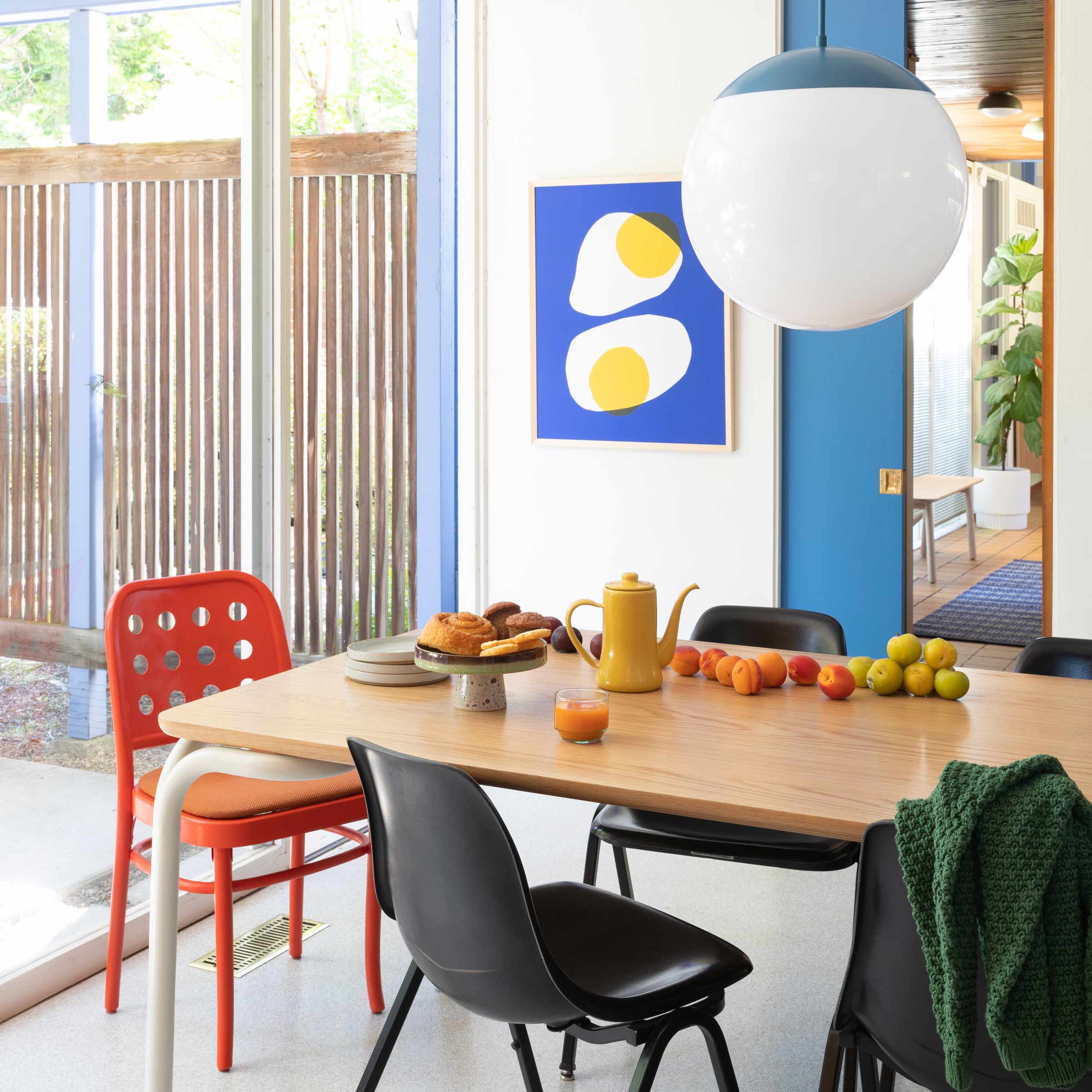 Large globe light over dining table.