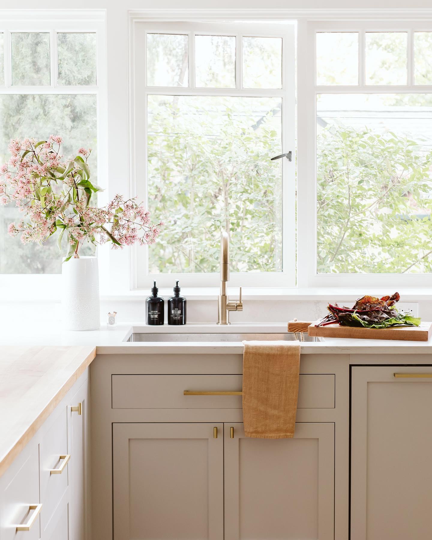 kitchen with white cabinets and a vase of flowers on the counter