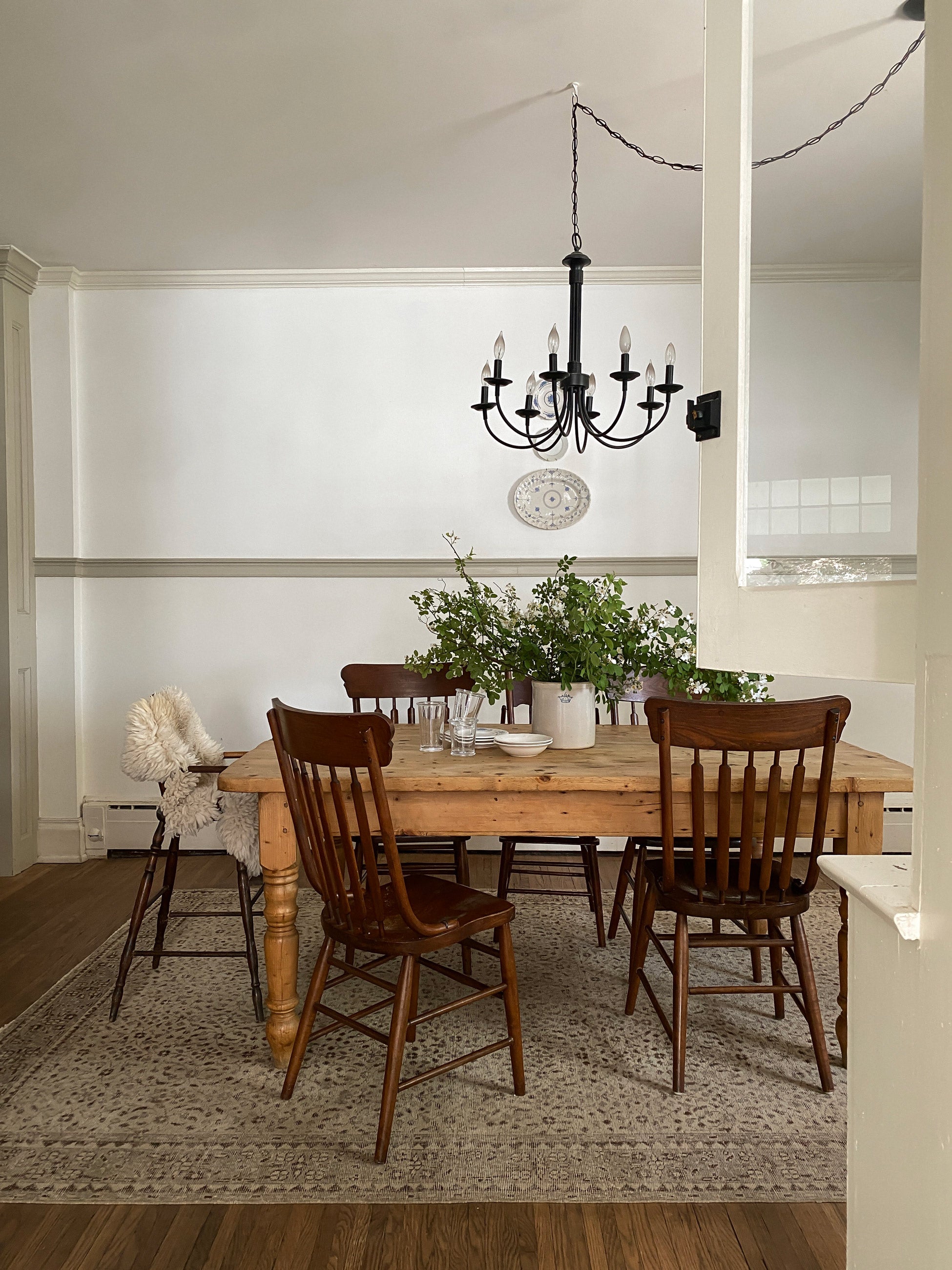 Traditional style dining room with chandelier over dining table. 