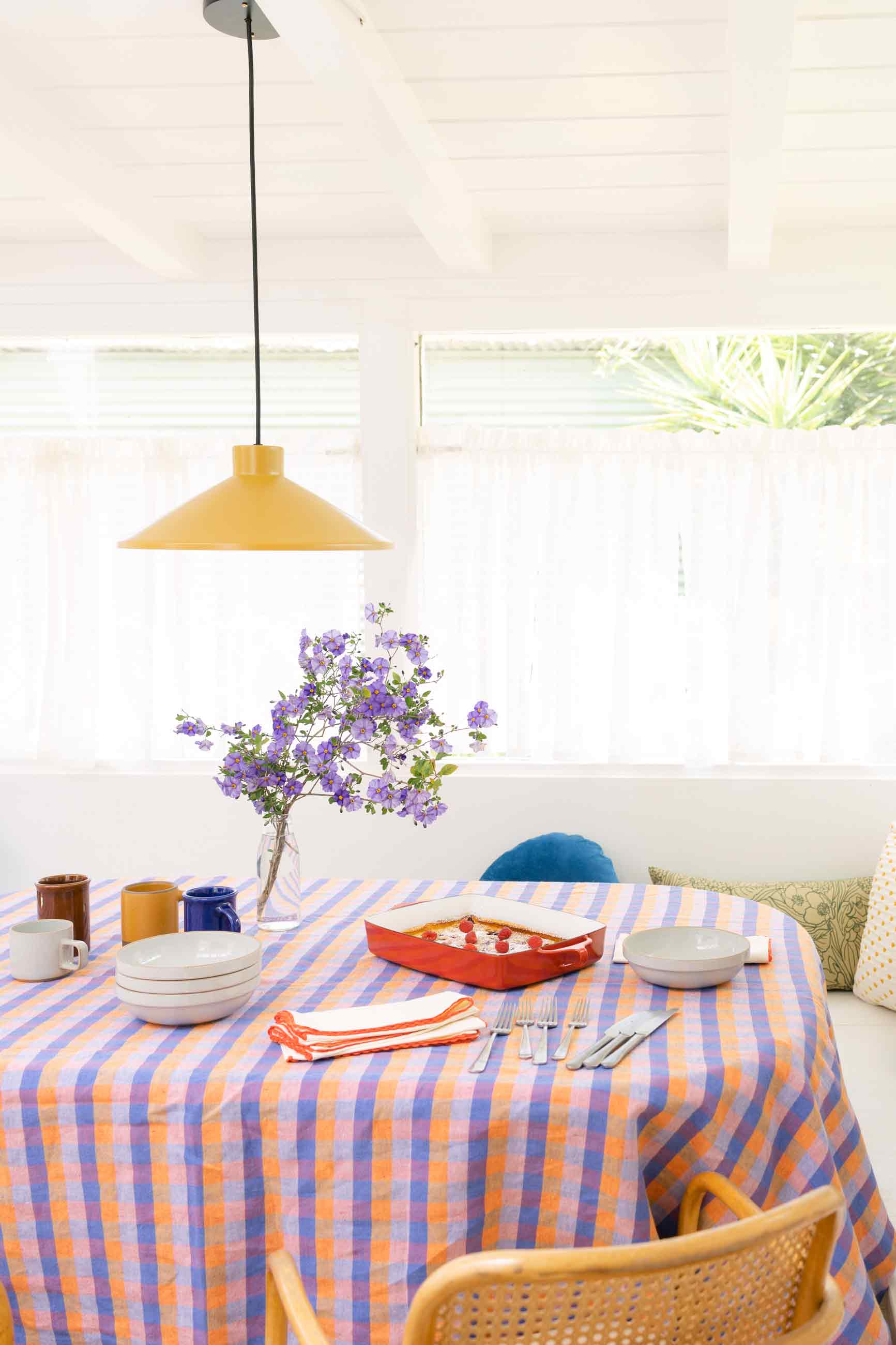 A vibrant summer tabletop with bright linens and dish ware. 