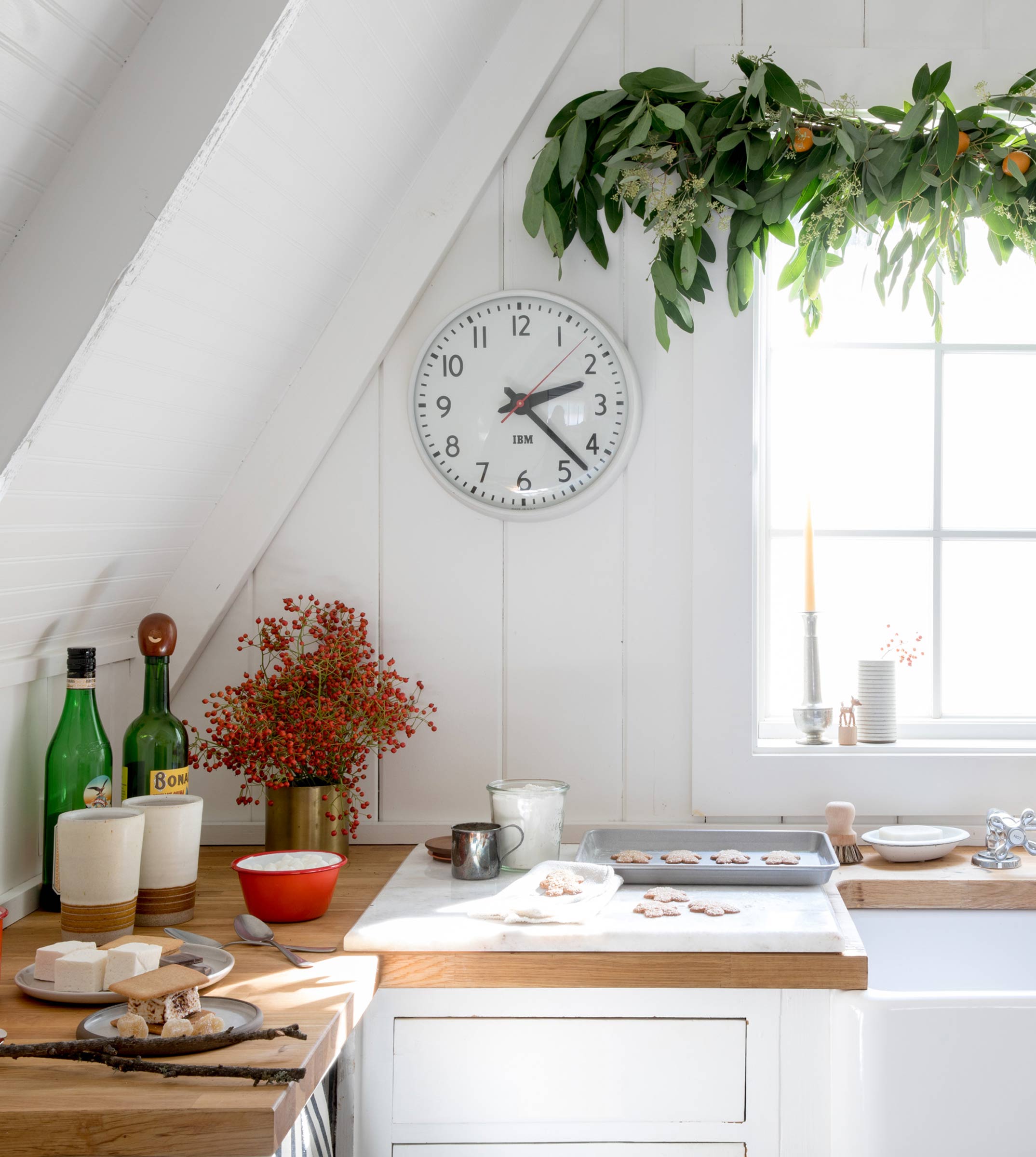 Vintage clock in a bright kitchen with a garland.