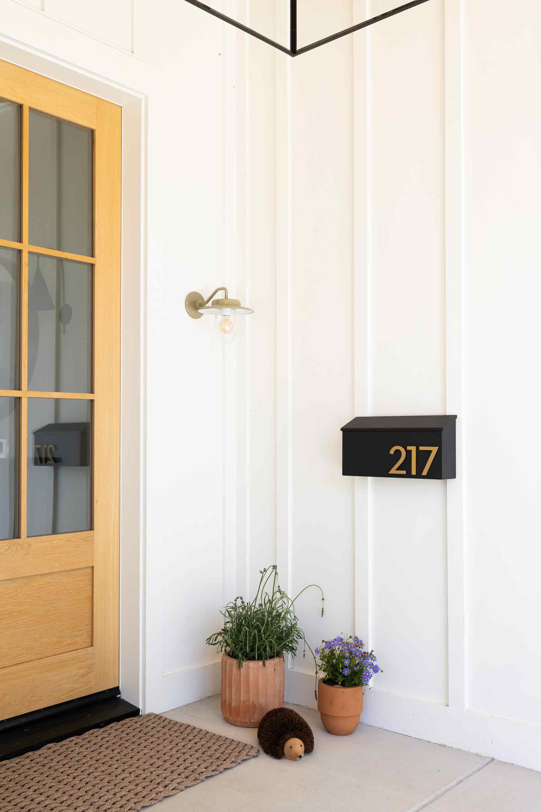 Simple front entrance of a white house. 