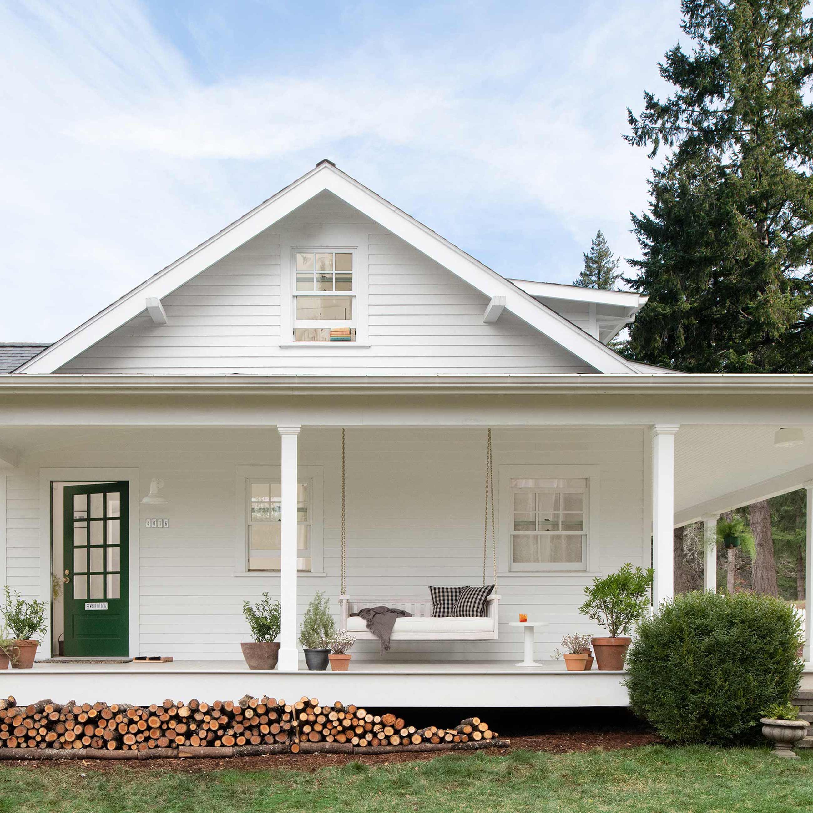 Wrap around porch on white house.