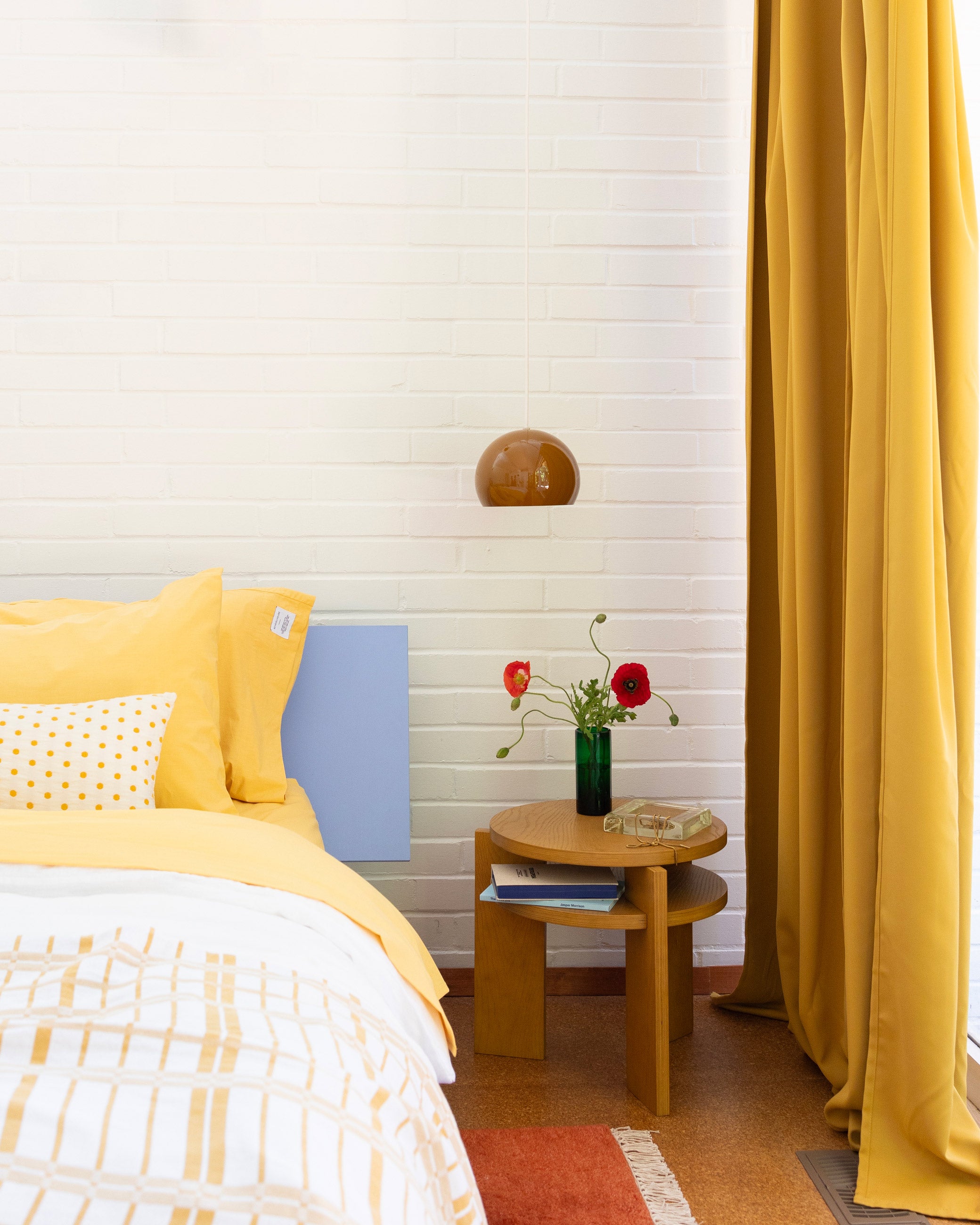 Bedroom with yellow and brown accents.