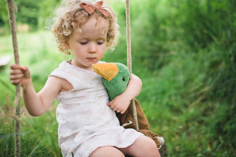 Girl on swing with organic cotton drake by senger toys