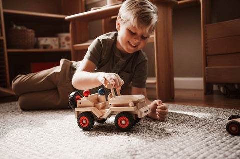 boy playing with fagus jeep