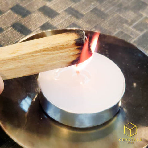 Use a candle to light the Palo Santo Stick