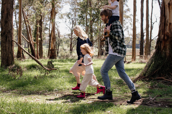 A family walking along a trail wearing Bobbi Gumboots