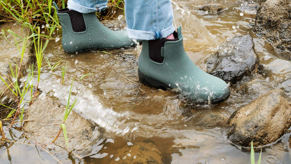 A person standing in water wearing Bobbi gumboots