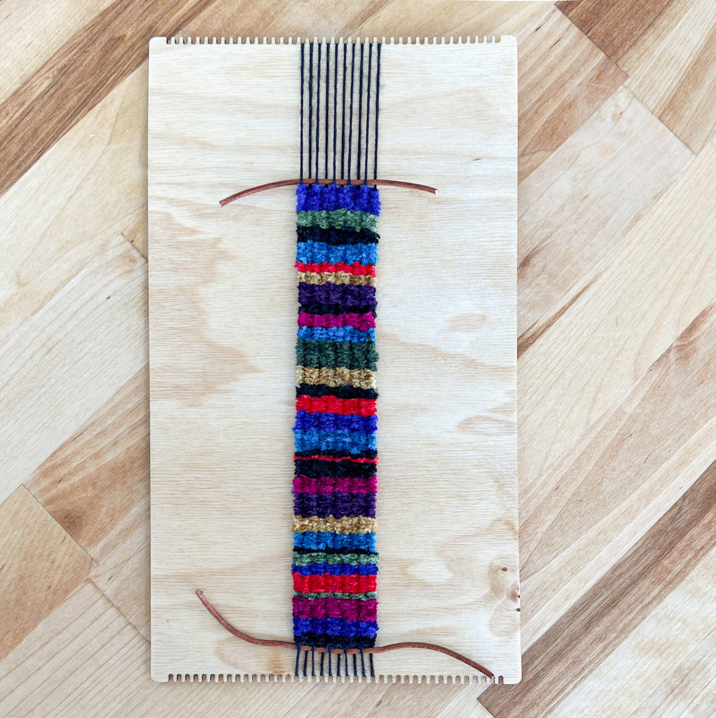 Chenille bracelet with leather cord woven in.