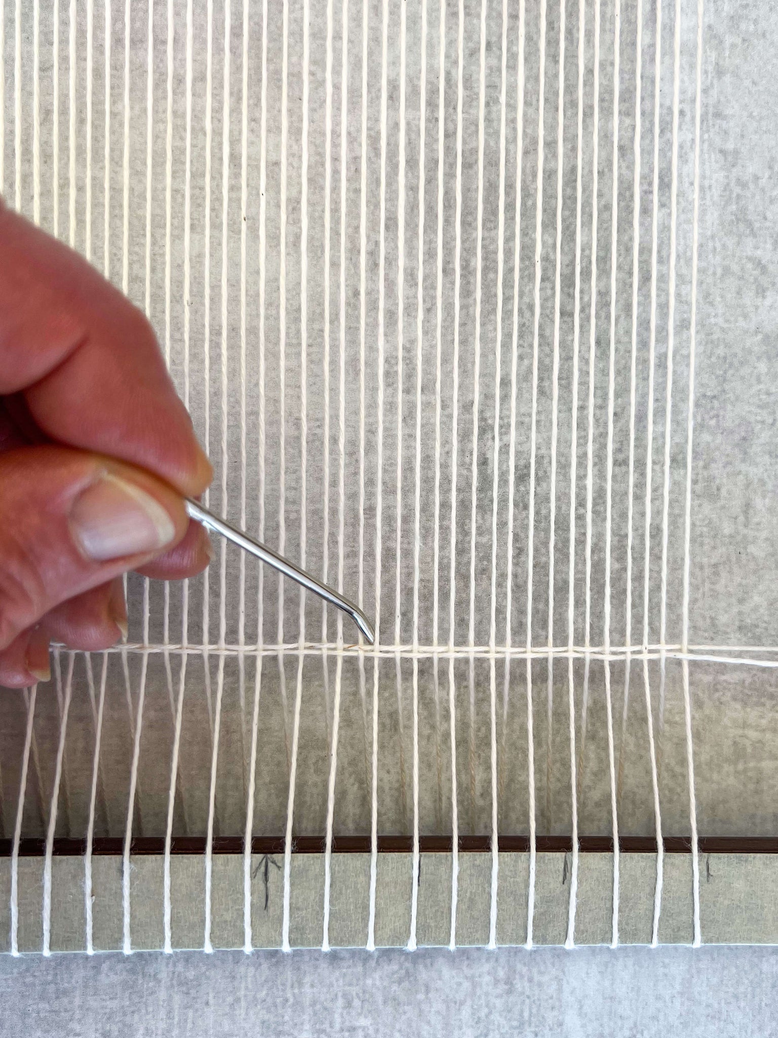 using a tapestry needle to pack down threads