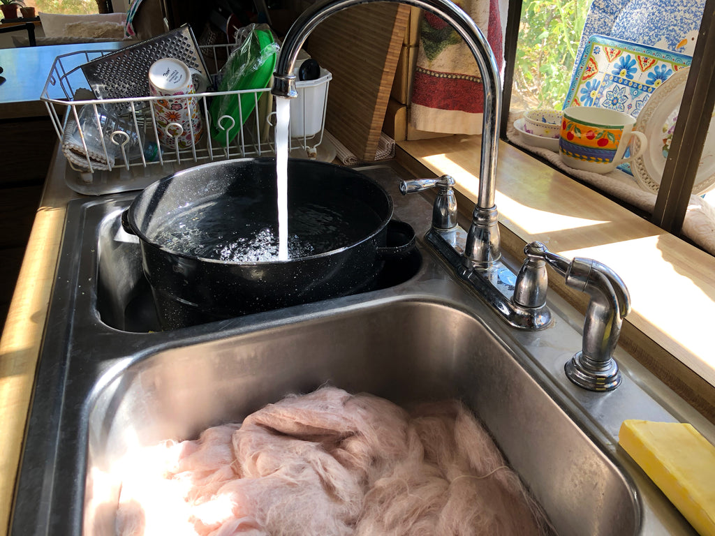 rinsing the wool in the sink