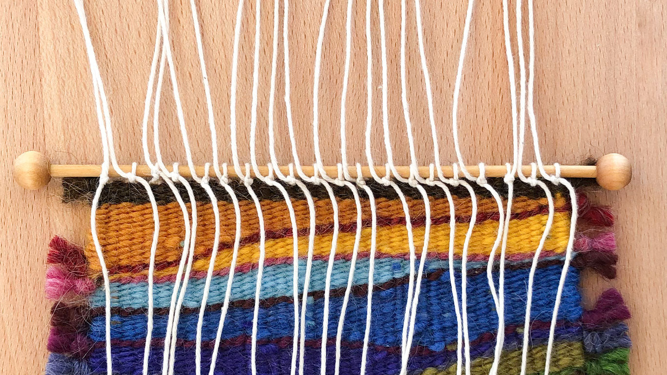 Tying warp on the back side of the weaving
