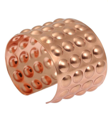 Stylish copper cuff bracelet featuring a unique dotted pattern, ideal for a chic and trendy look.